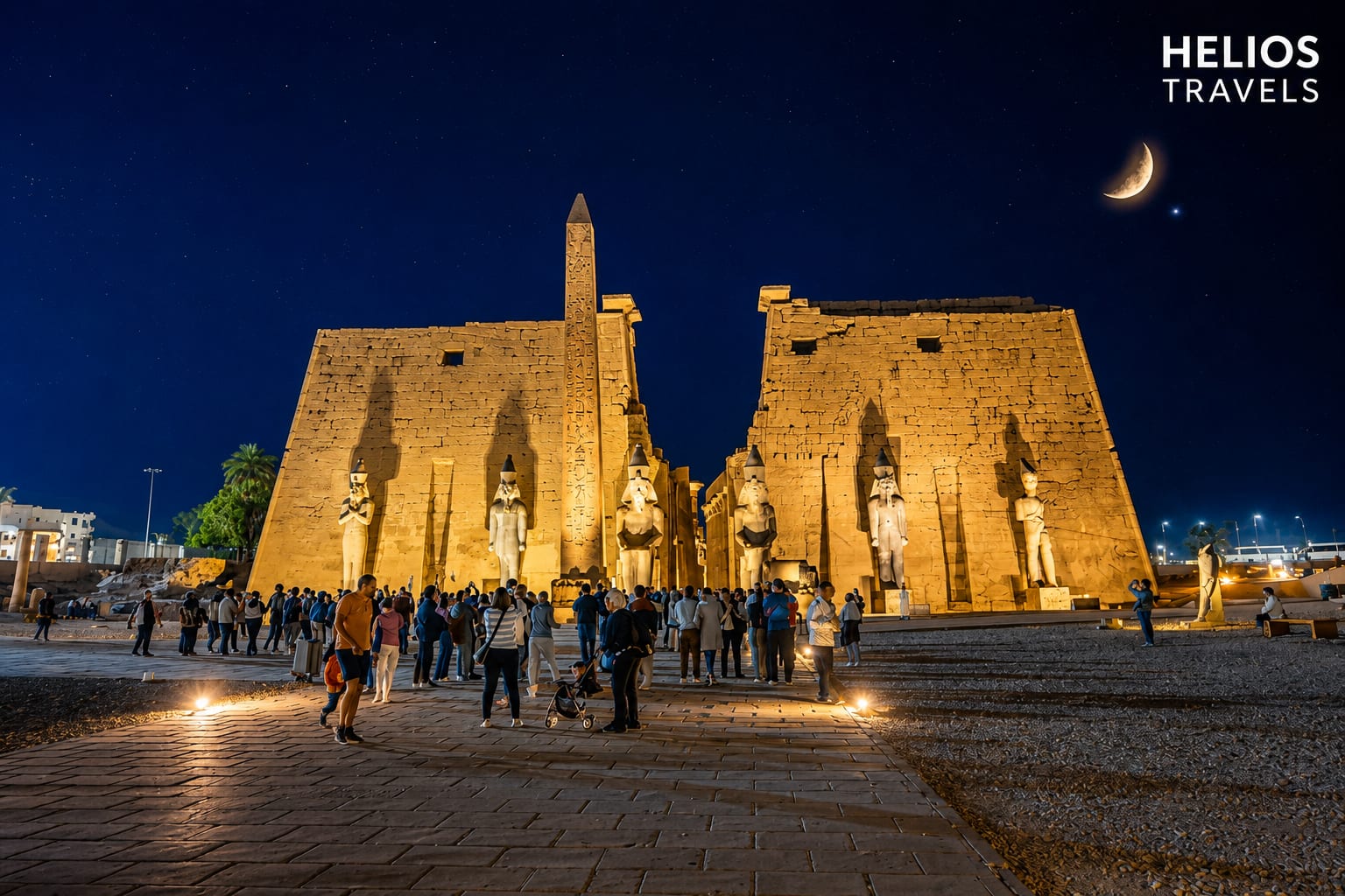 Luxor Temple lit at dusk, its columns and pylon glowing against a deep blue sky
