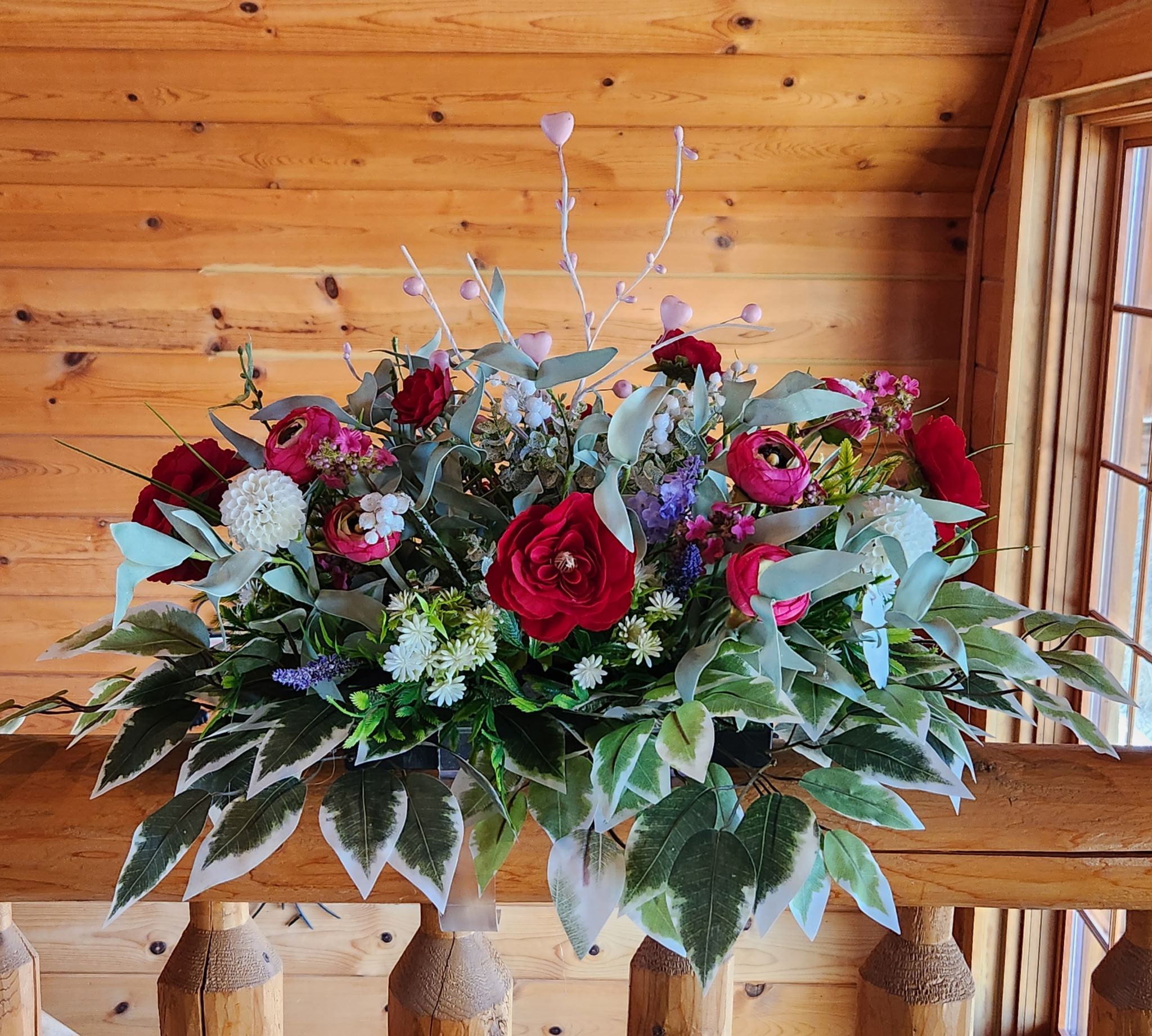 Red, white, and purple flowers with pink heart branches and leaves with white tips