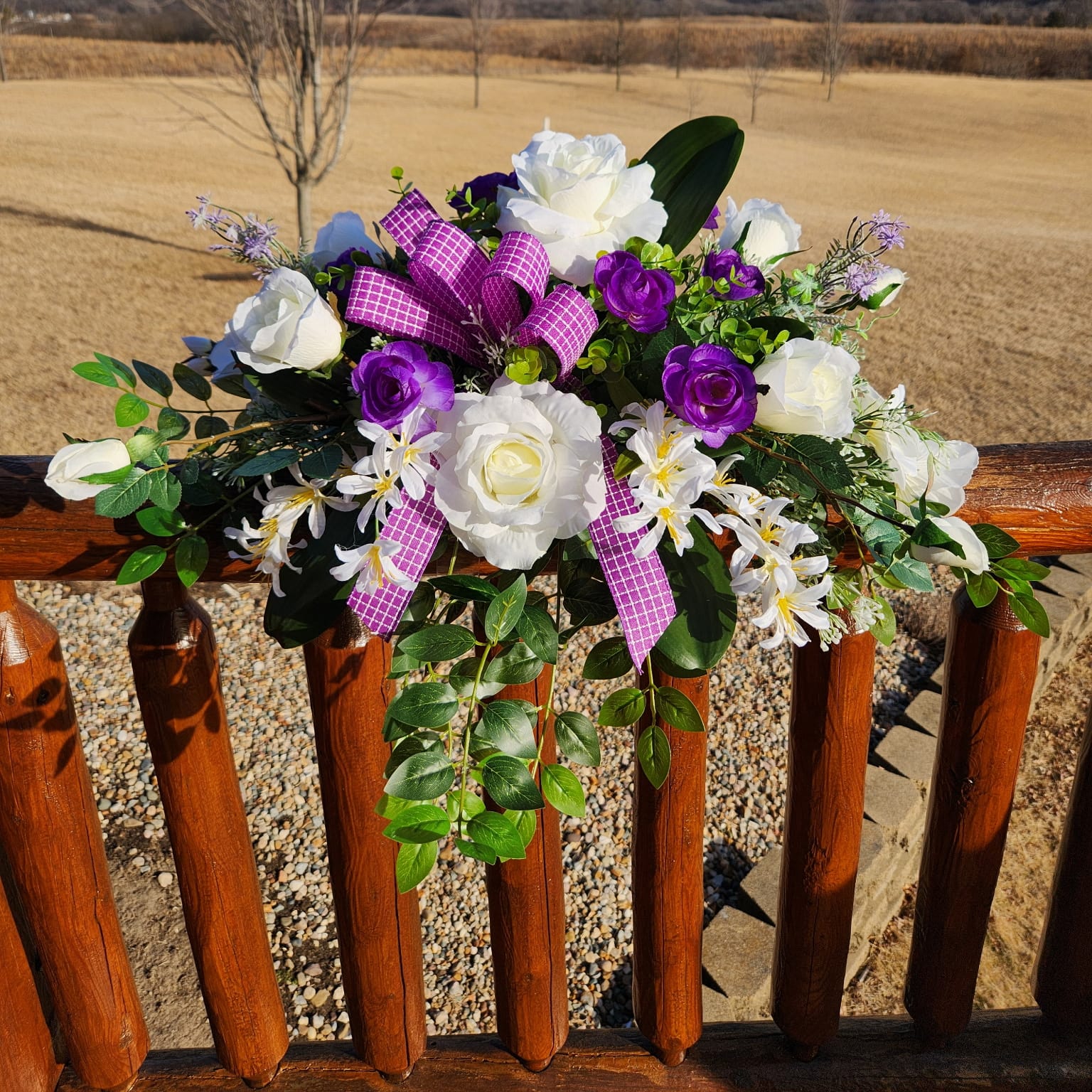White and purple flowers with a purple and white plaid ribbon