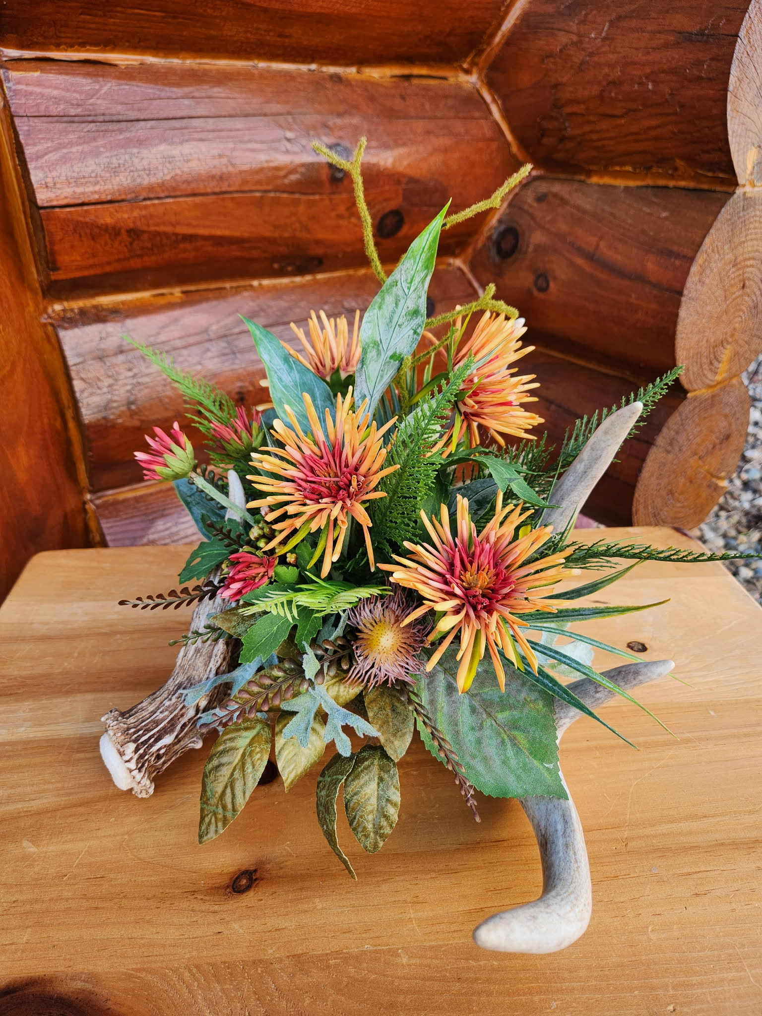 Deer antlers with orange flowers and leaves