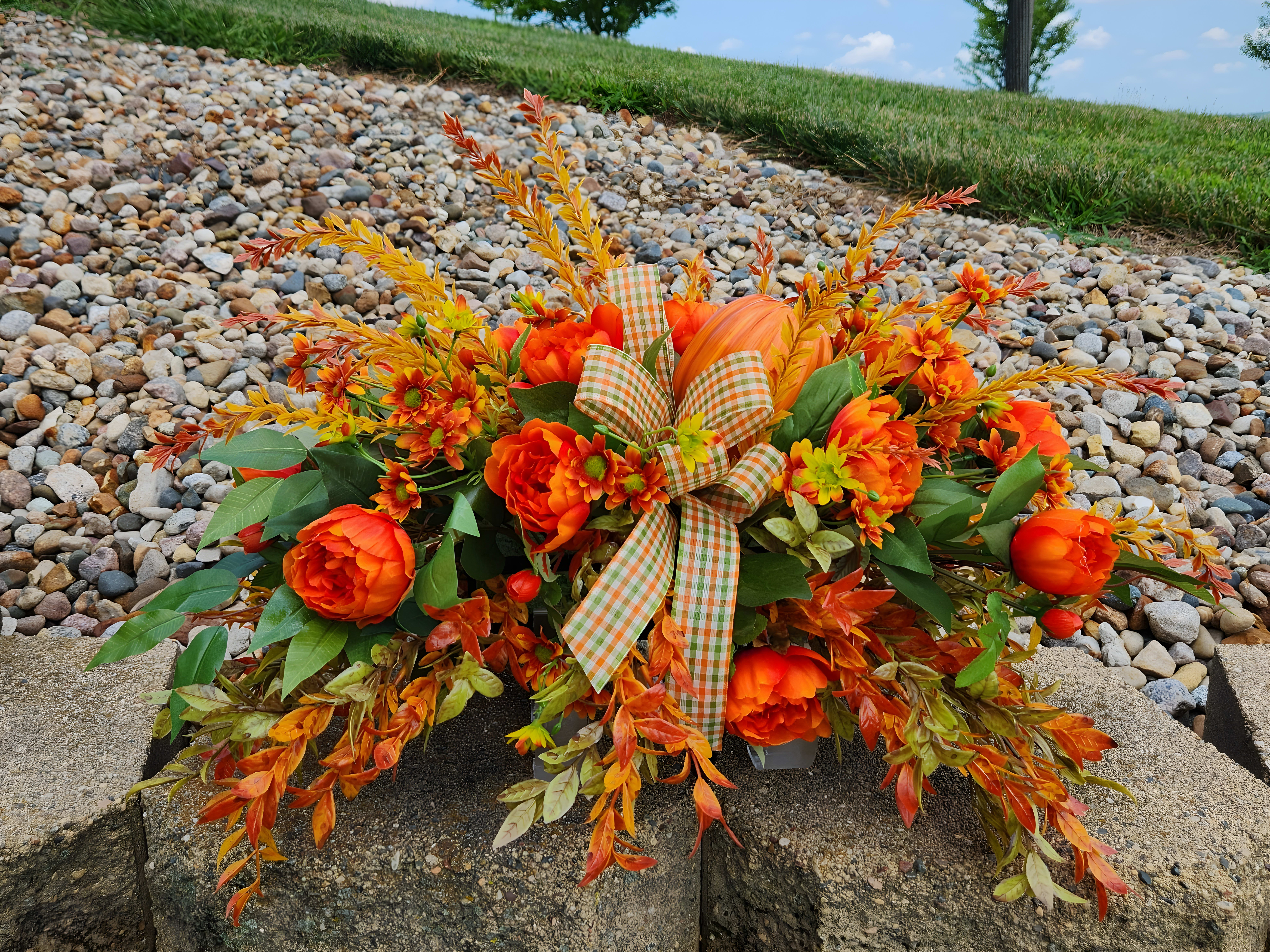 Fall themed arrangement with orange plaid ribbon