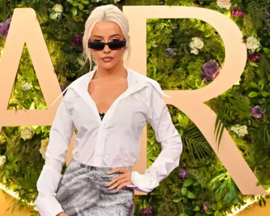 Christina Aguilera on the Joy Awards red carpet in a long black gown with dramatic sleeves