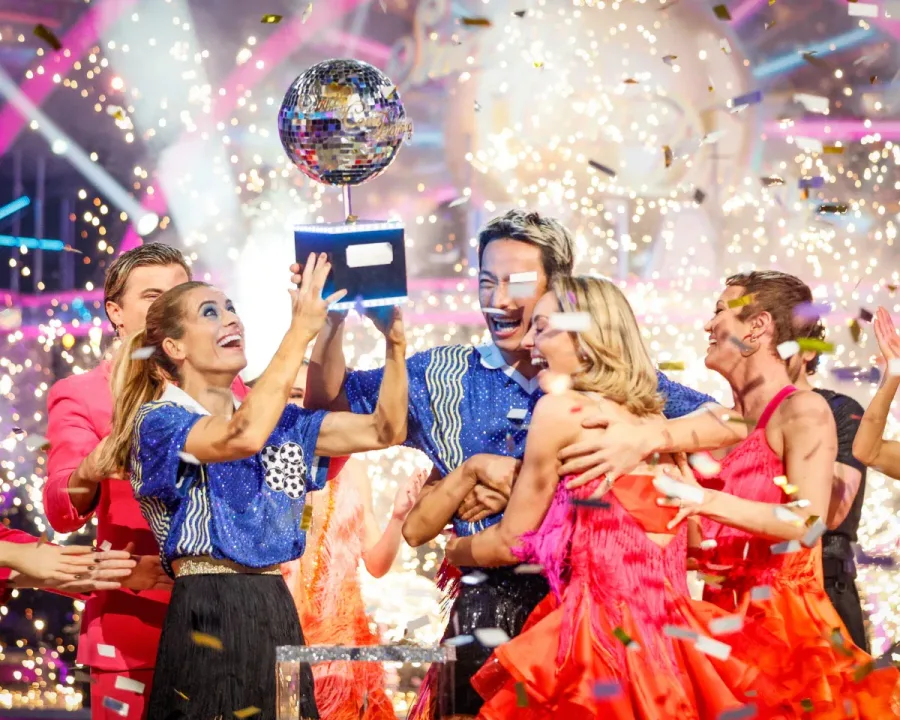 Karen Carney and Carlos Gu hold their glitter-ball trophy after winning the 2025 series of Strictly Come Dancing