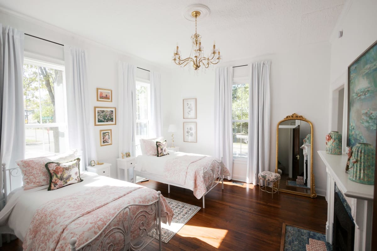 Wide view of the Pastel Room with toile wallpaper and lace bedding
