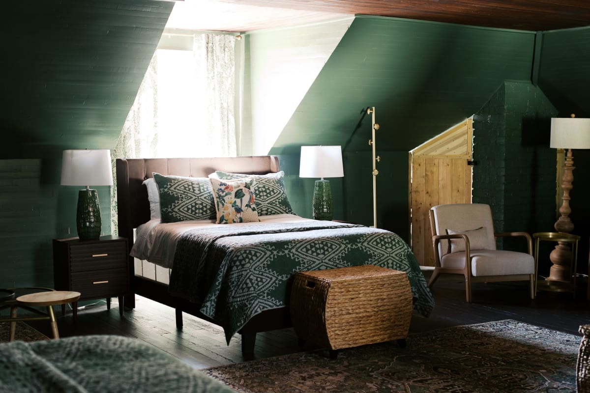 Attic bedroom detail: pine beams, vintage iron bed frame