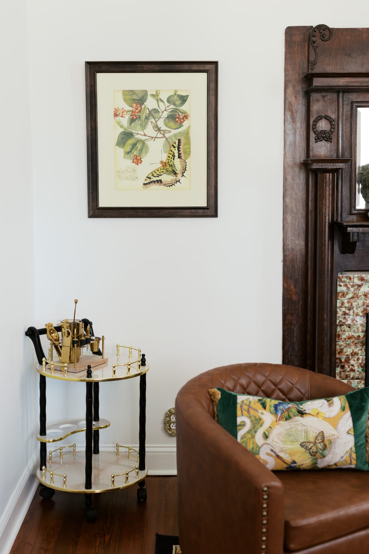 The Parlor: brass bar cart, framed butterfly print, the original 1890 mantel