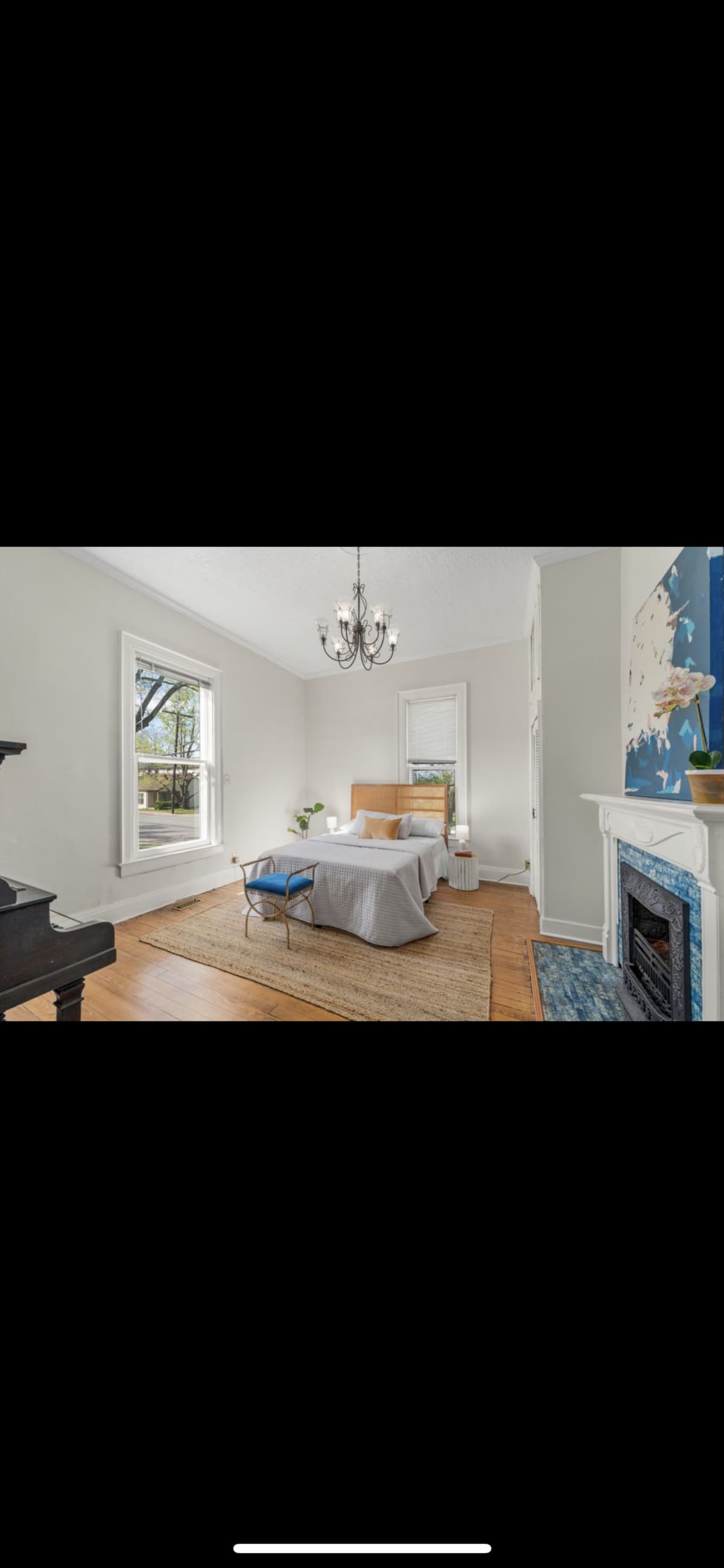The Pastel Room before restoration — simple bedroom with blue-tiled fireplace and bare walls