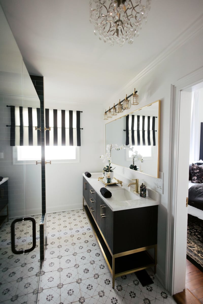 Bathroom with gold stripes and brass fixtures