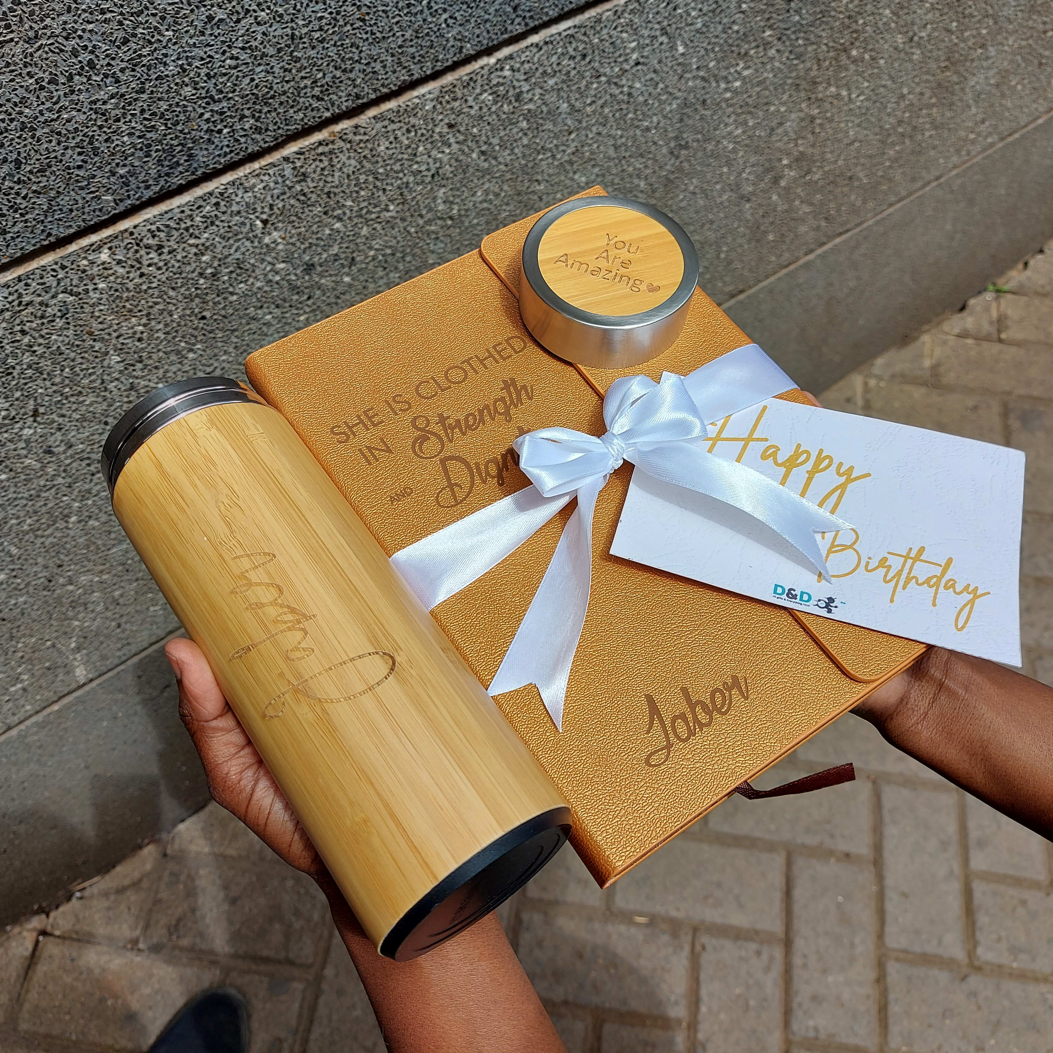 Gold notebook and a bamboo thermal bottle.