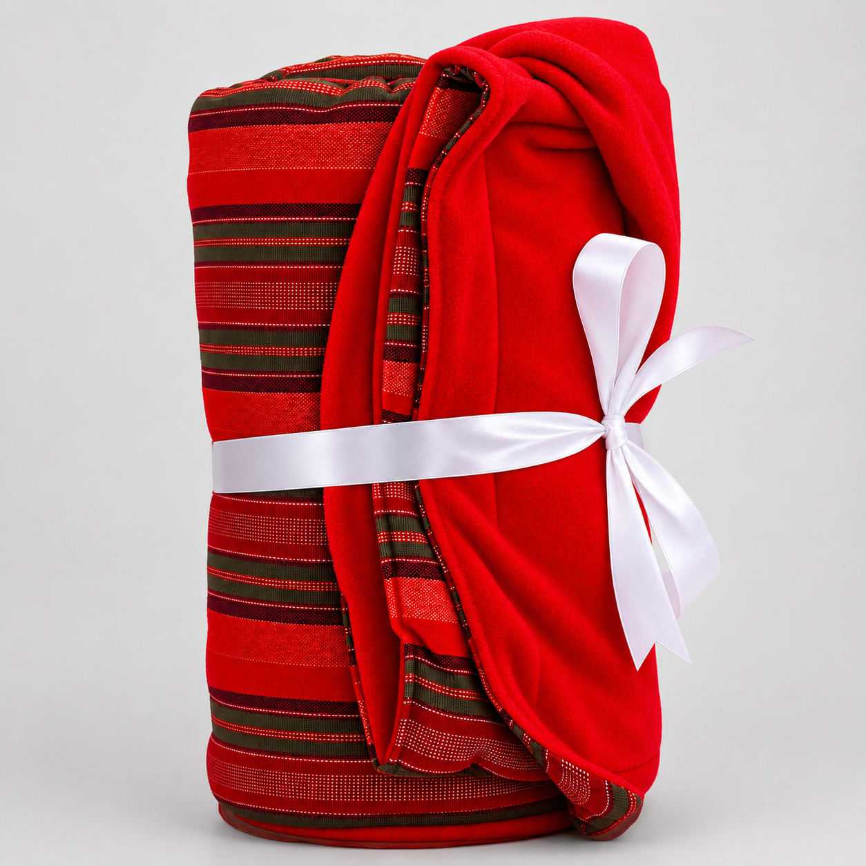 Plain red Maasai fleece blanket tied with a white ribbon gift bow