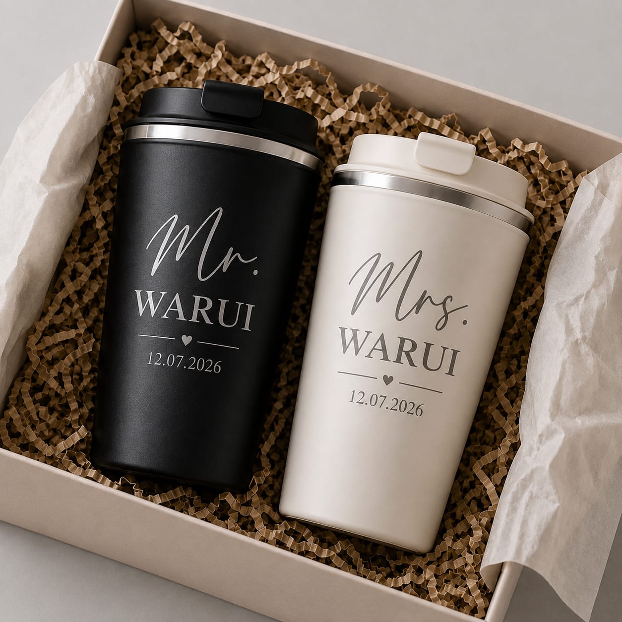 Custom laser engraved matte black and cream thermal travel mugs set for couples personalized with Mr. and Mrs. Warui and wedding date in a gift box.