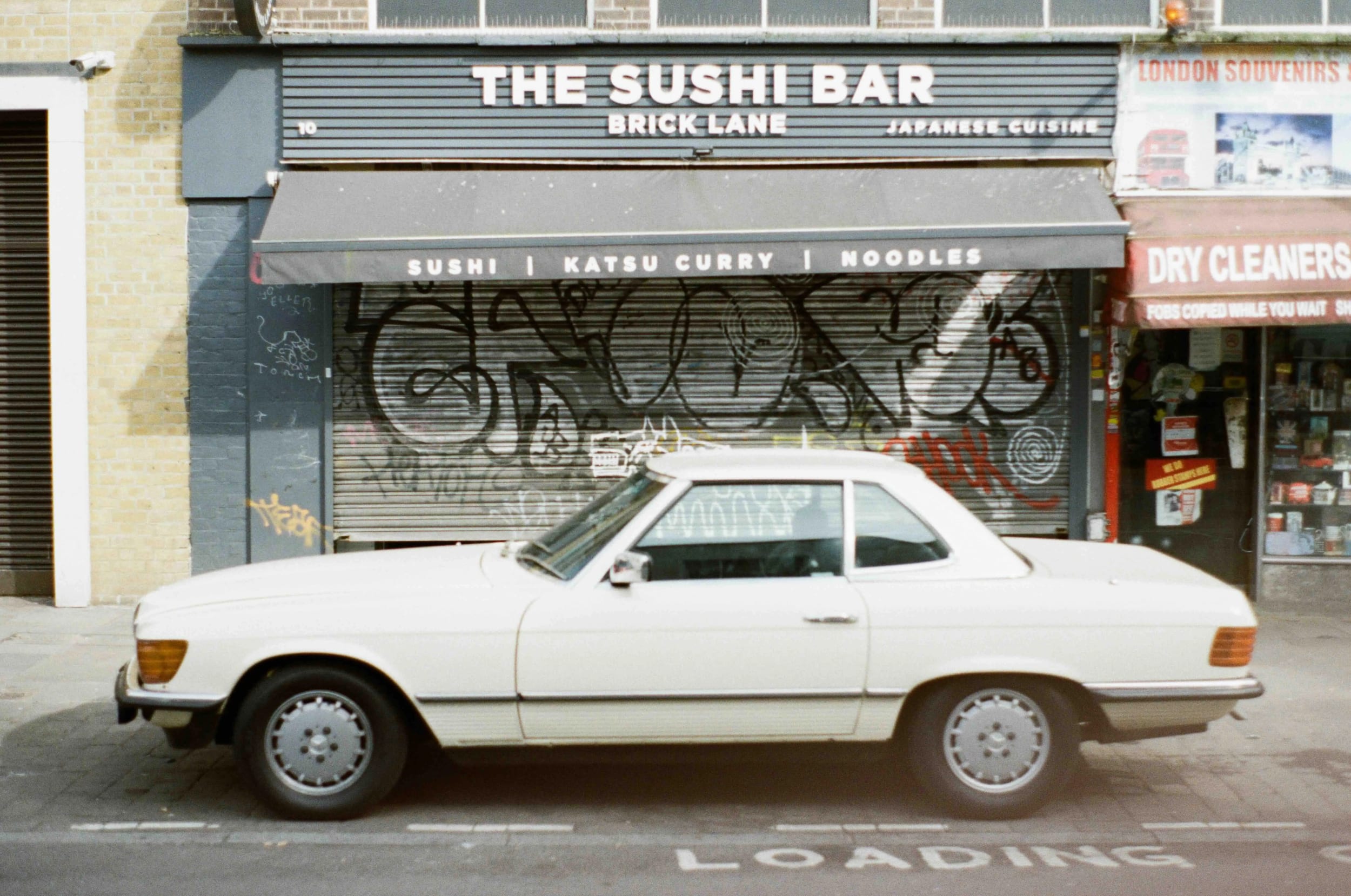 Car in front of Sushi bar