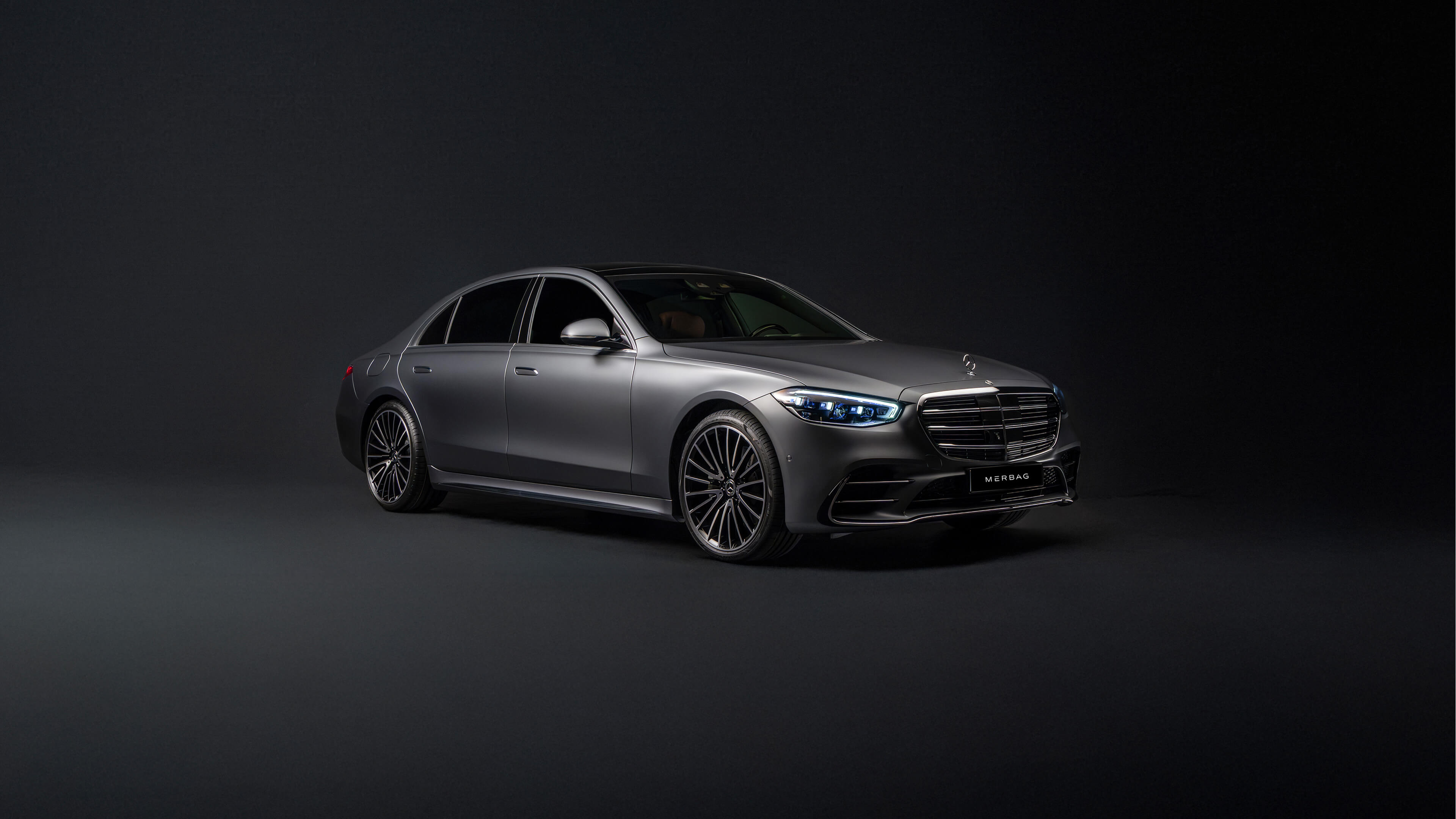 Professional chauffeur opening a Mercedes S-Class door