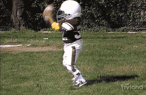 GIF of kid throwing down touchdown football