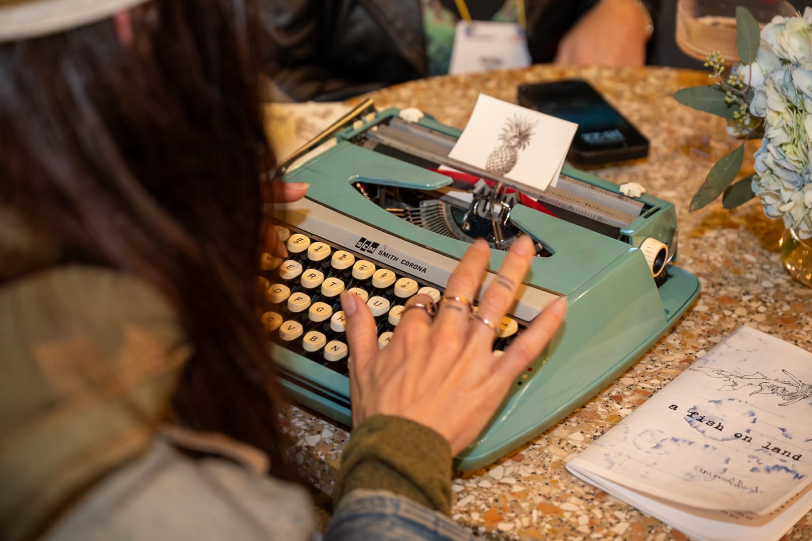 Poet at Swoogo's UNCON writing a custom poem for an attendee during a one-on-one interaction