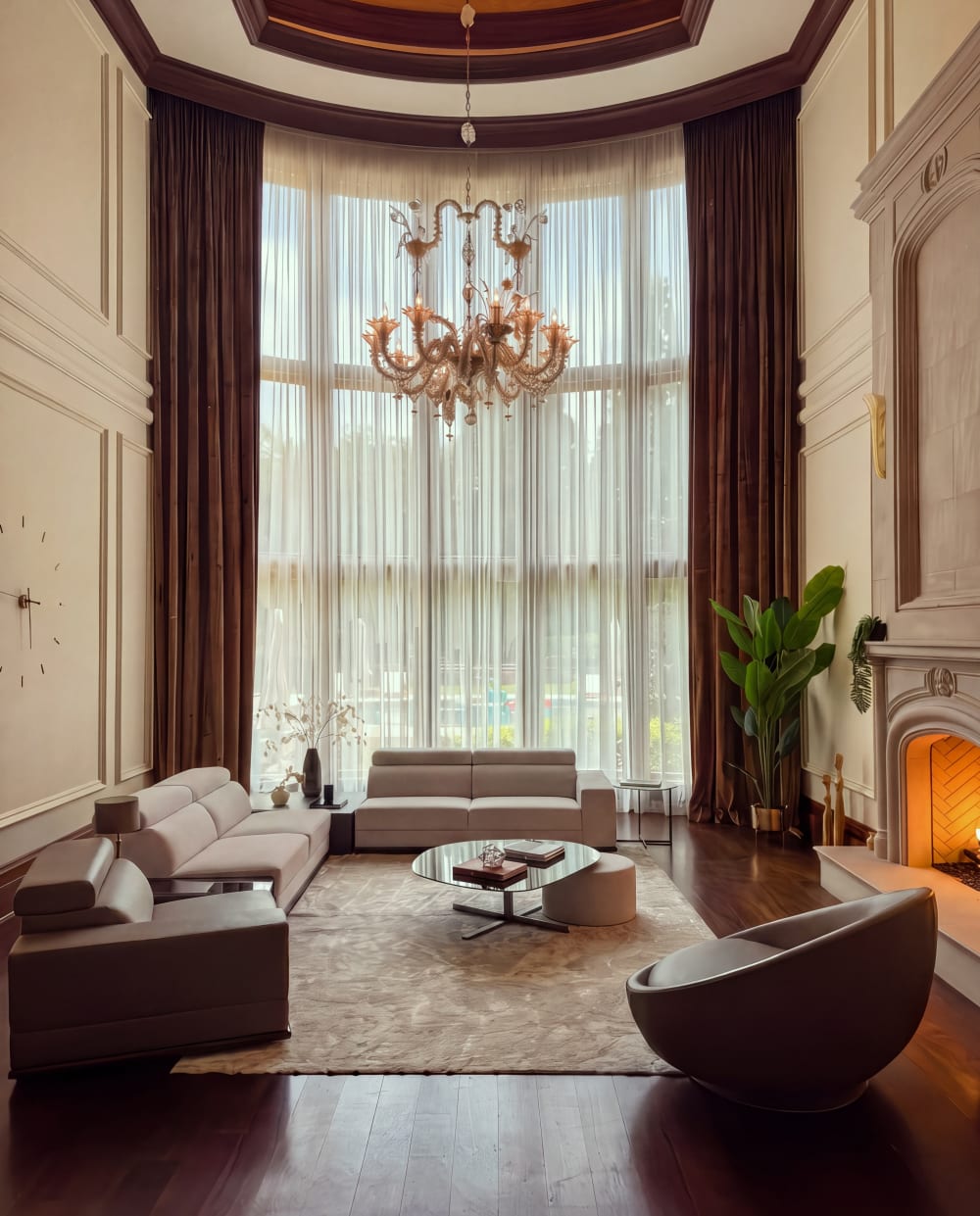 Double-height living room with a chandelier at Fauzan Country Club