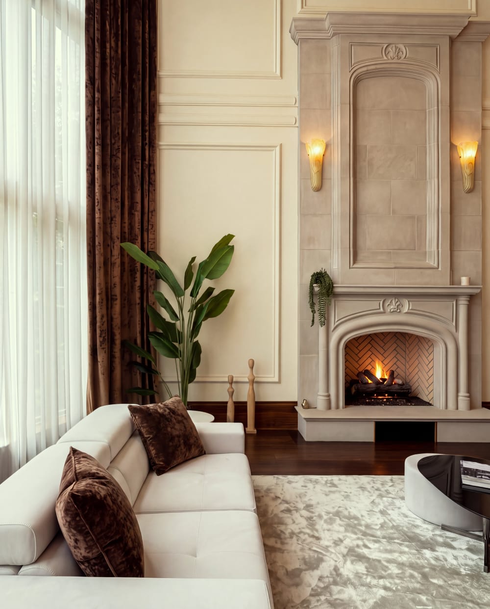 Living room with a tall stone fireplace at Fauzan Country Club