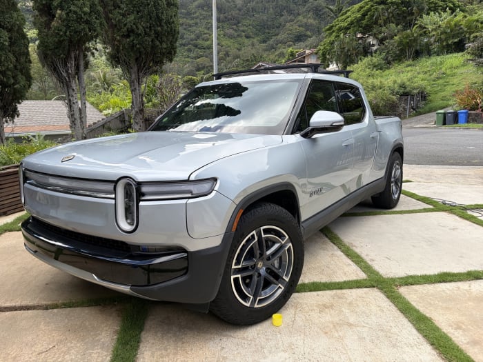 Silver Rivian R1T detailed, Oahu valley behind