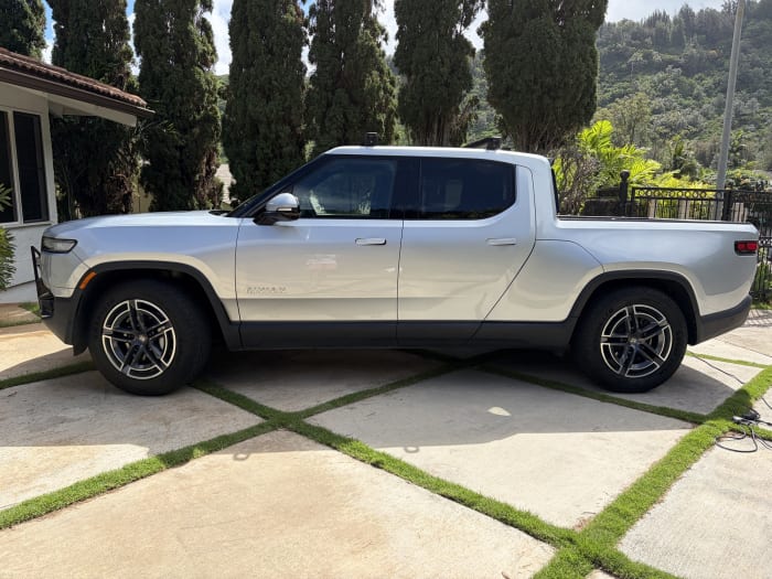 Rivian R1T side profile after a full detail on an Oahu driveway