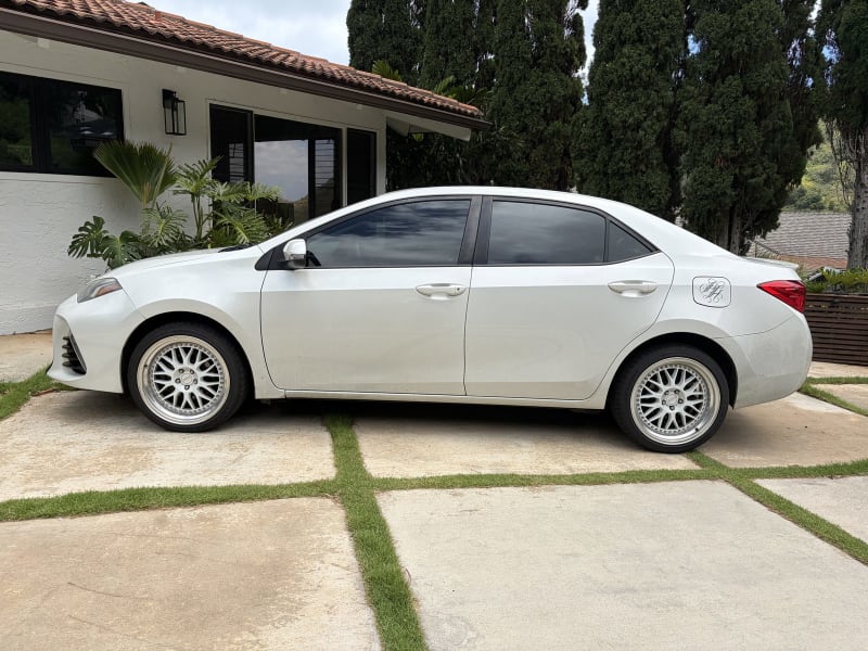 White Toyota Corolla side profile after exterior detailing on Oahu
