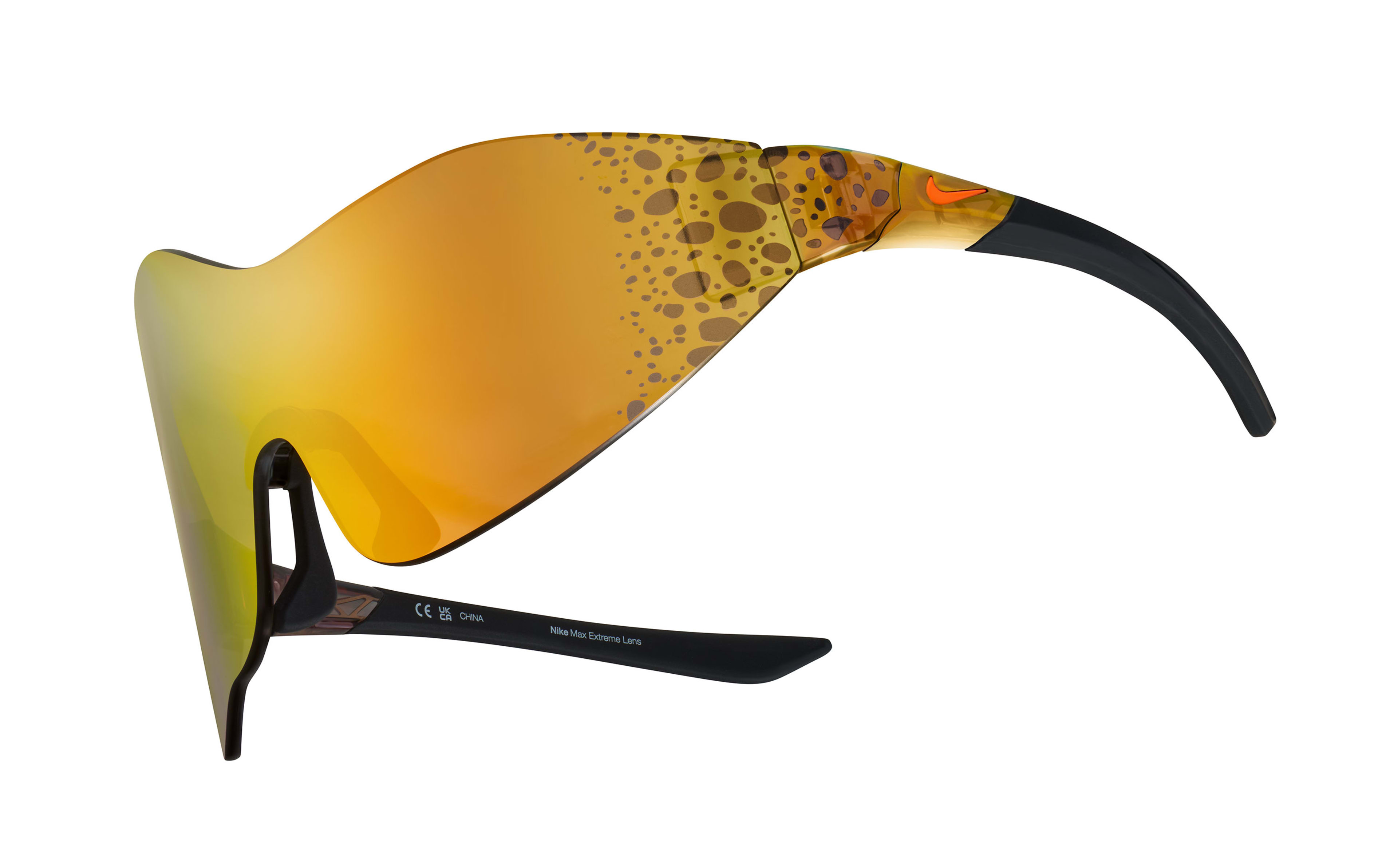 Front angled view of the Nike Athena sunglasses, showcasing the wrapping asymmetrical mirrored orange lens with Electric graphic at the temples. Electric graphic is a pattern of brown/black speckled spots.   Glasses float on a white background.