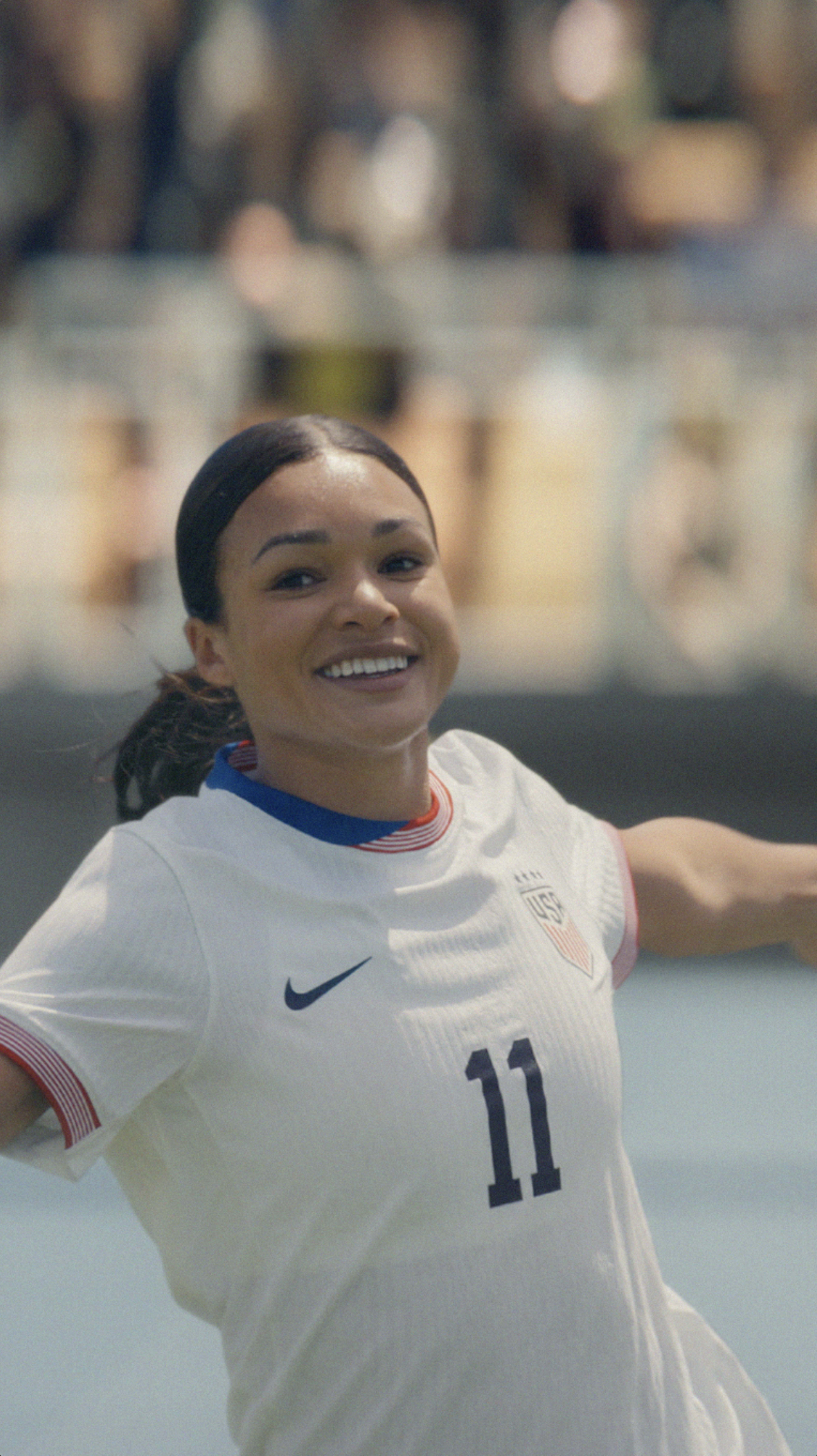 Close up of Sophia Smith in her Team USA football jersey, showing number 11, smiling and celebrating after a goal.