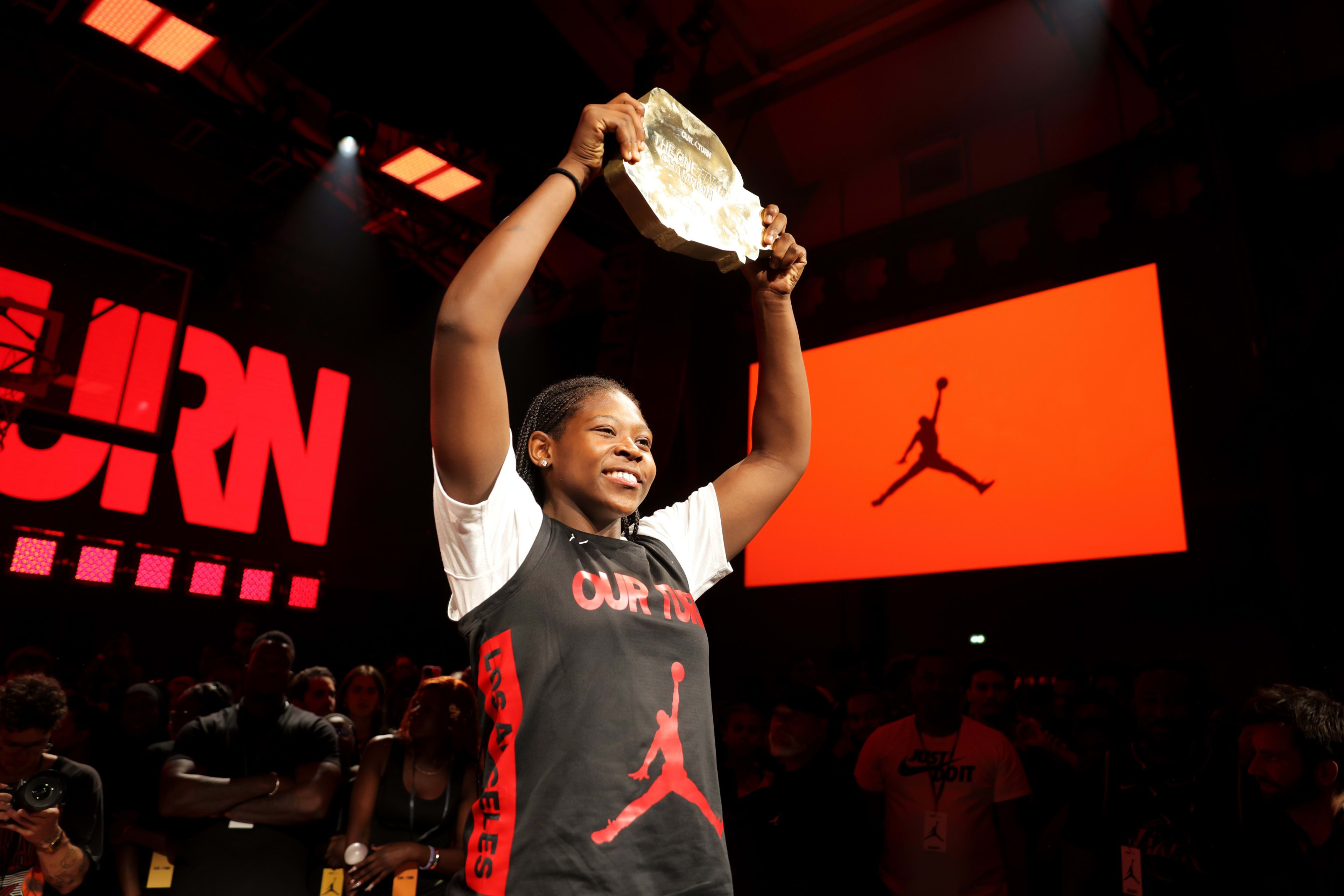 Tatianna Griffin holding a trophy at The One finals in Paris.