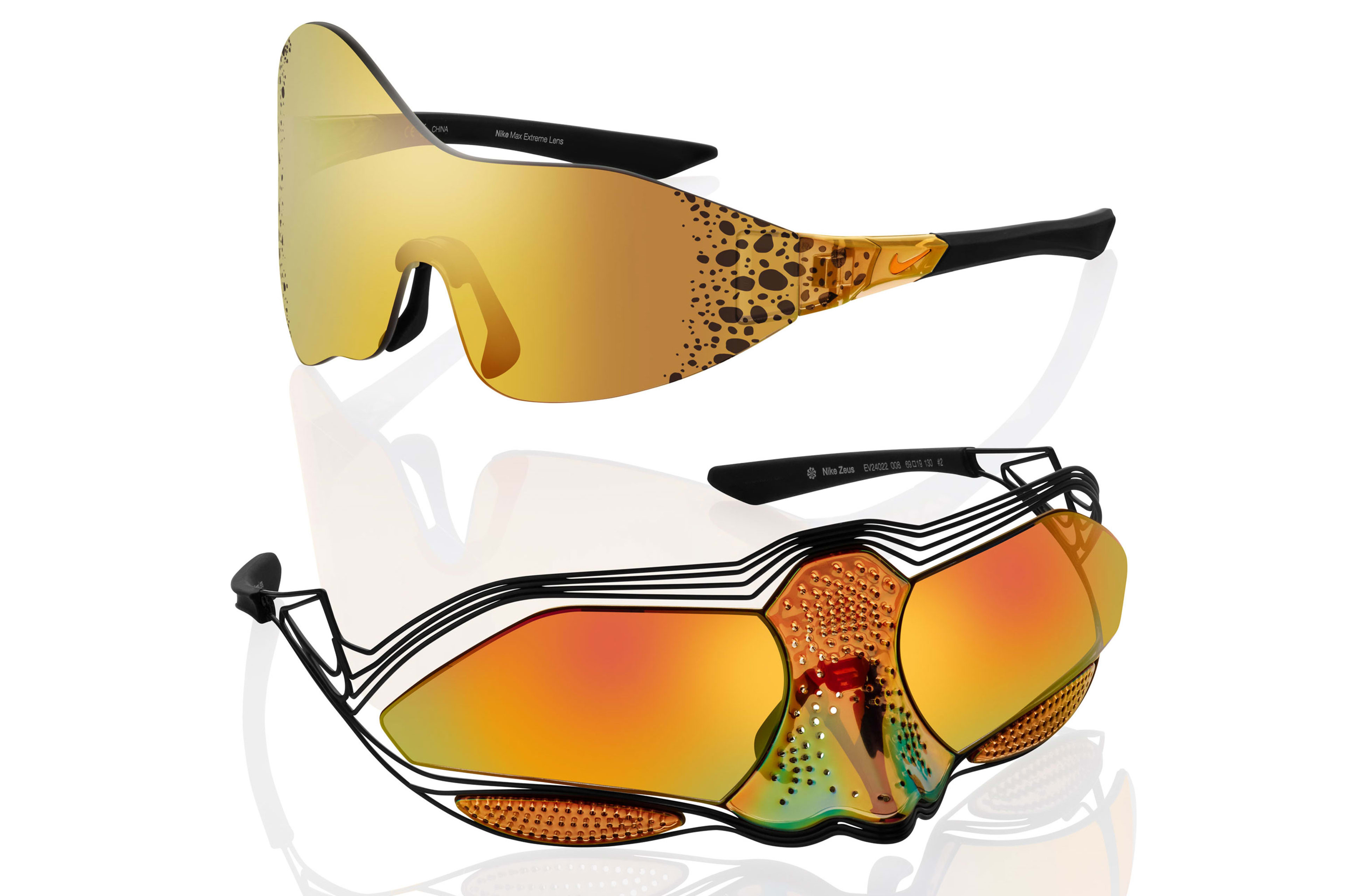 Front angled view of the Nike Athena (top) and Nike Zeus (bottom) sunglasses. Glasses sit on a white polished surface reflecting the glasses shadow. Both sunglasses are orange in hue with mirrored lenses that wrap the face.