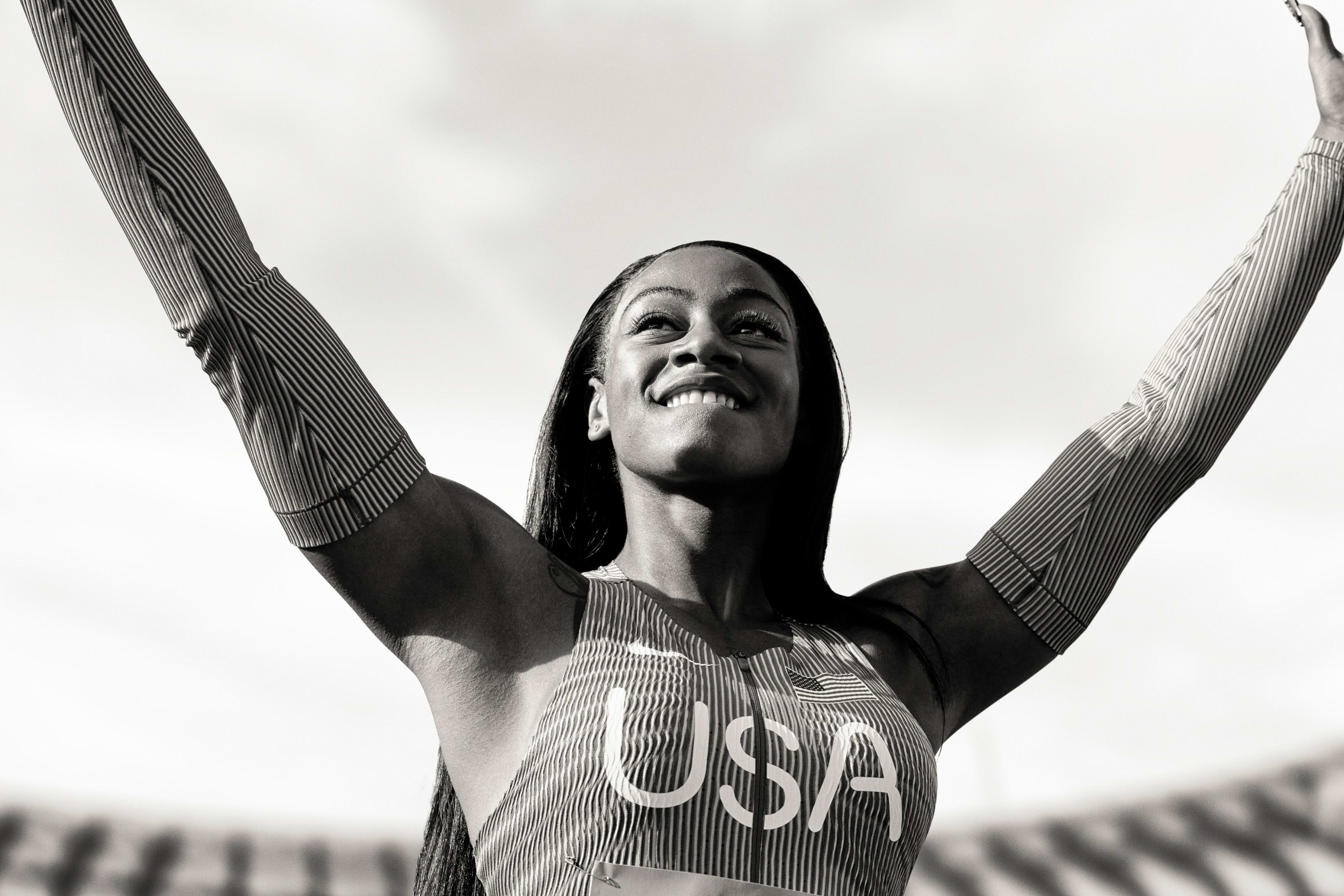 Black and white photo of Sha'Carri Richardson striking a victory pose.