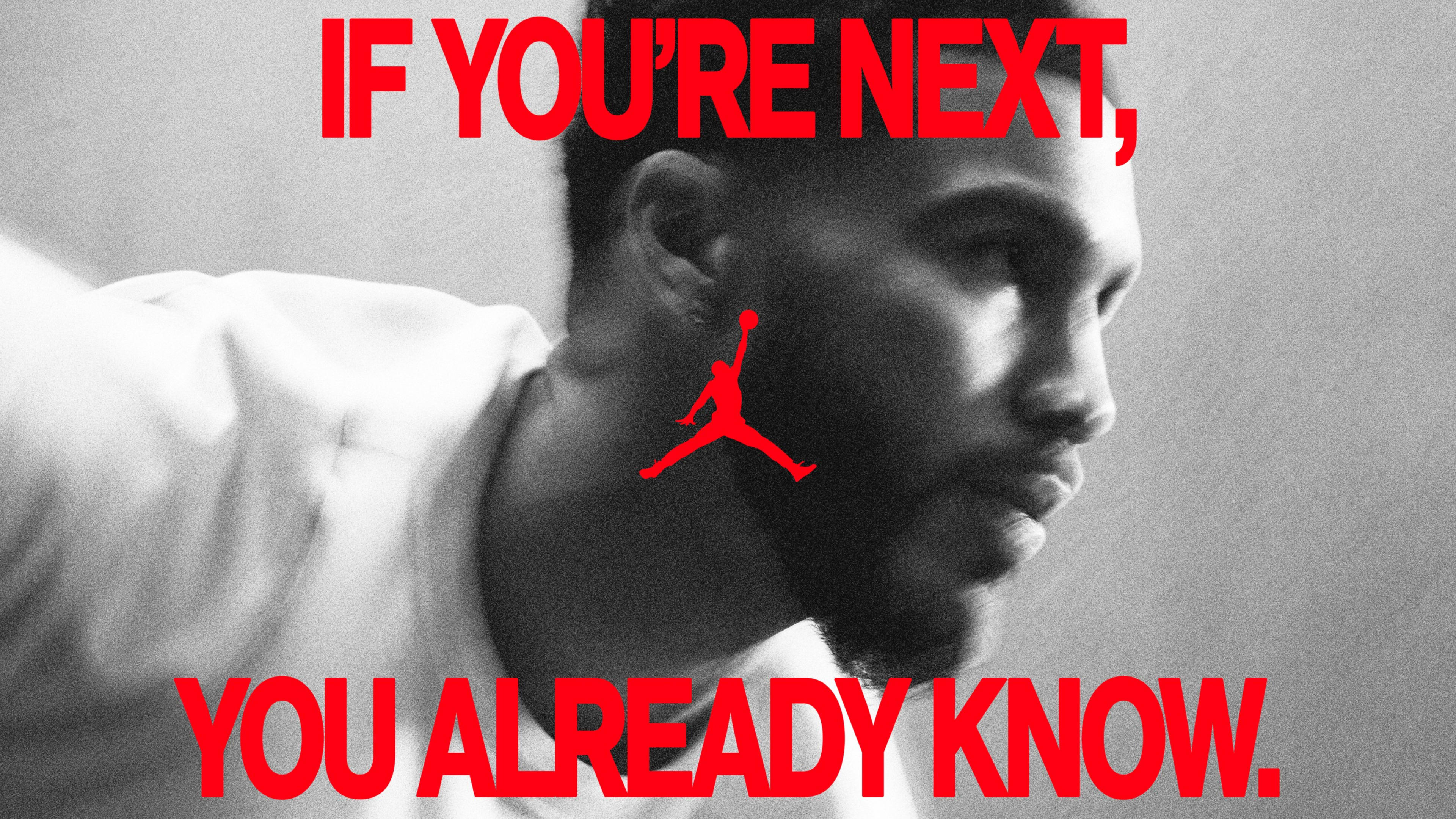 Black and white close up side angle view of an athlete in a readied pose. A red caption reads, "If you're next, you already know." The Air Jordan logo is in the center.