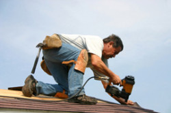 Allen Roofing & Sheet Metal Inc. - Man Replacing Roof