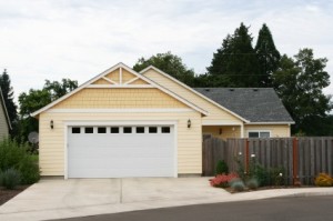 Suppa and Sons Overhead Doors- Yellow Home With Garage