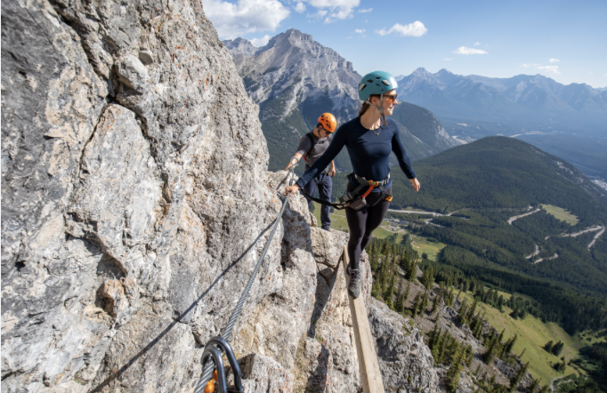Hikers at the base of a snowy mountain