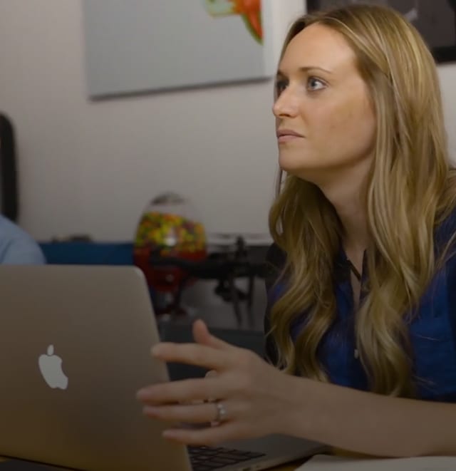 Girl sitting at office table with laptop