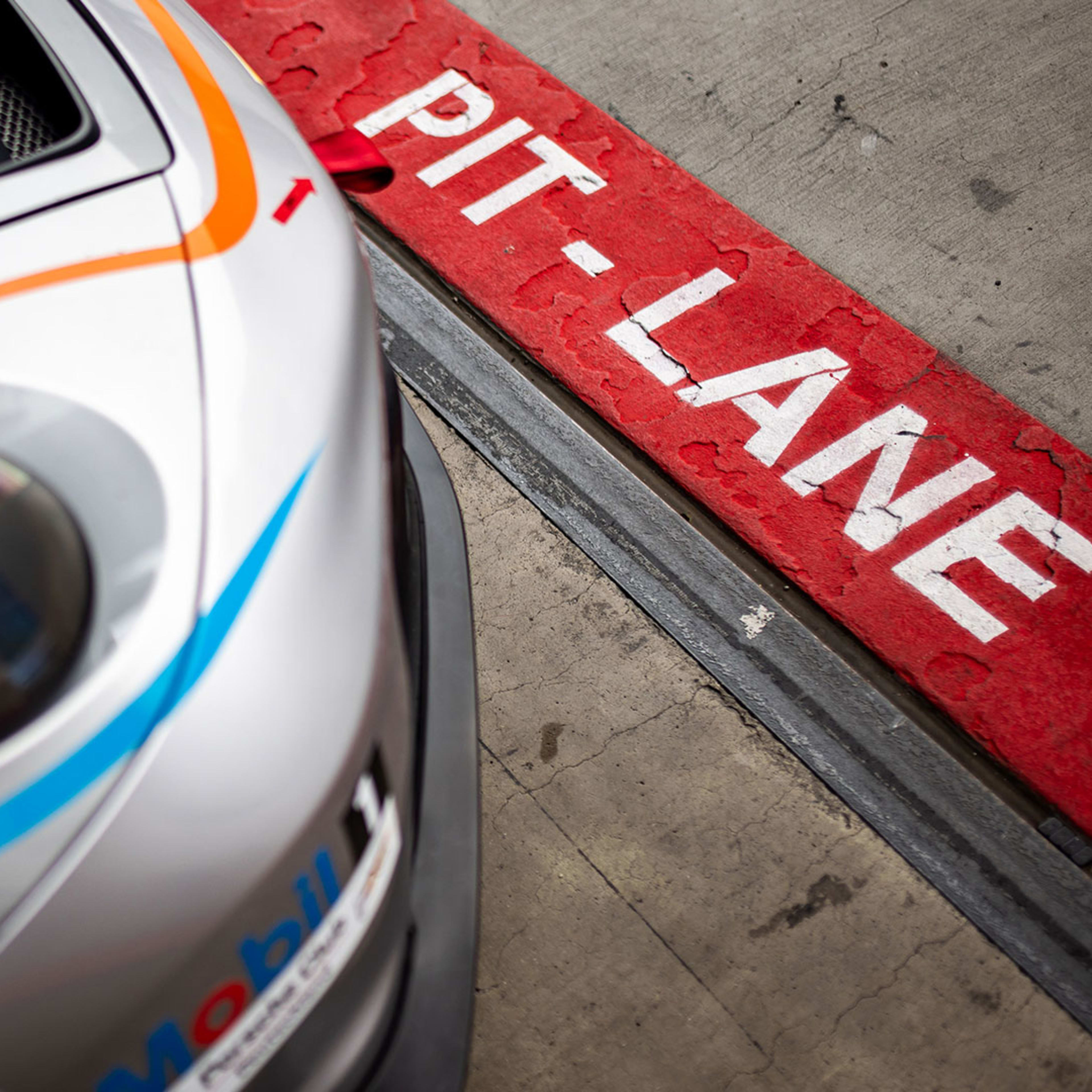 A Porsche 911 GT3 Cup (992) in the pits in front of the pit lane.