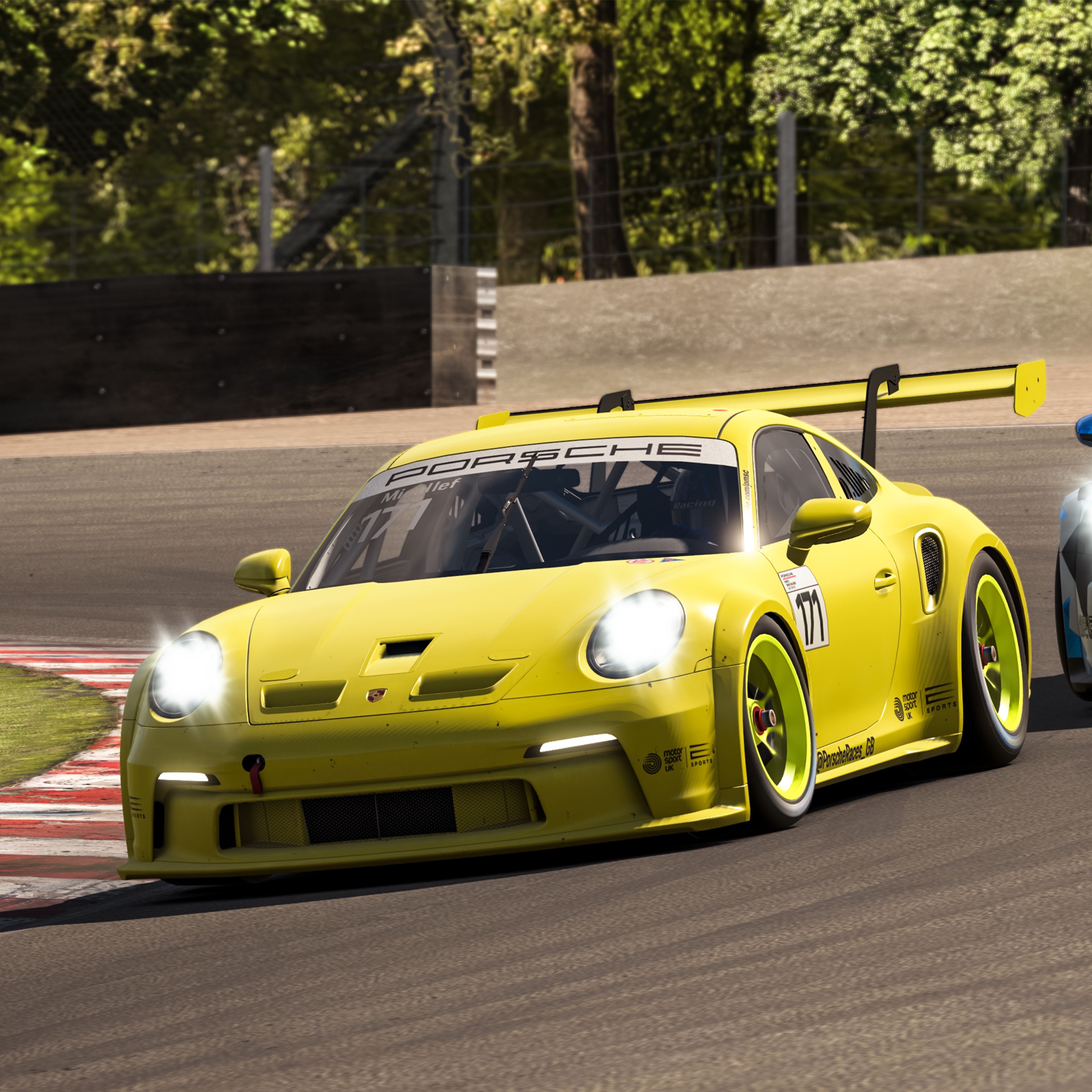 Arial view of virtual 911 taking a corner on Silverstone racetrack.