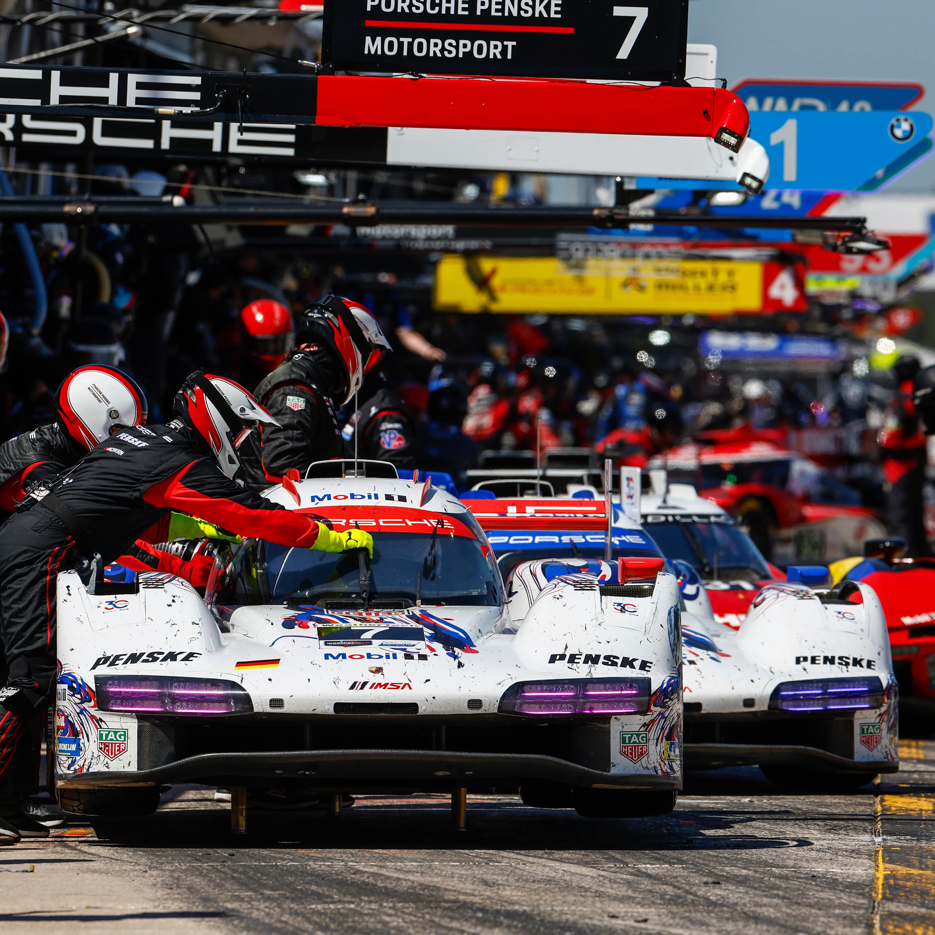 The two Porsche Penske Motorsport cars make a pitstop during the 2026 12 Hours of Sebring