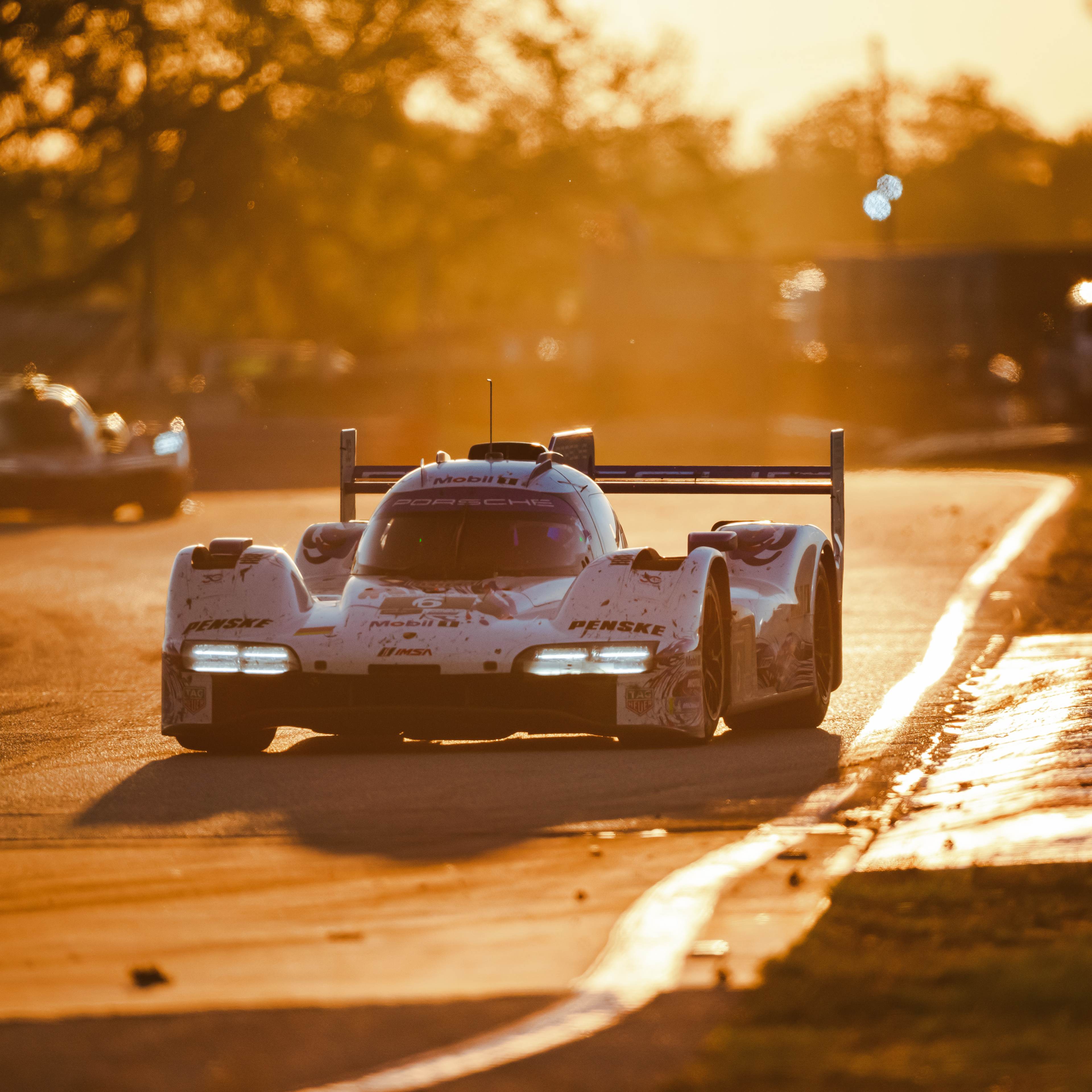 The #6 car turns a corner at sunset