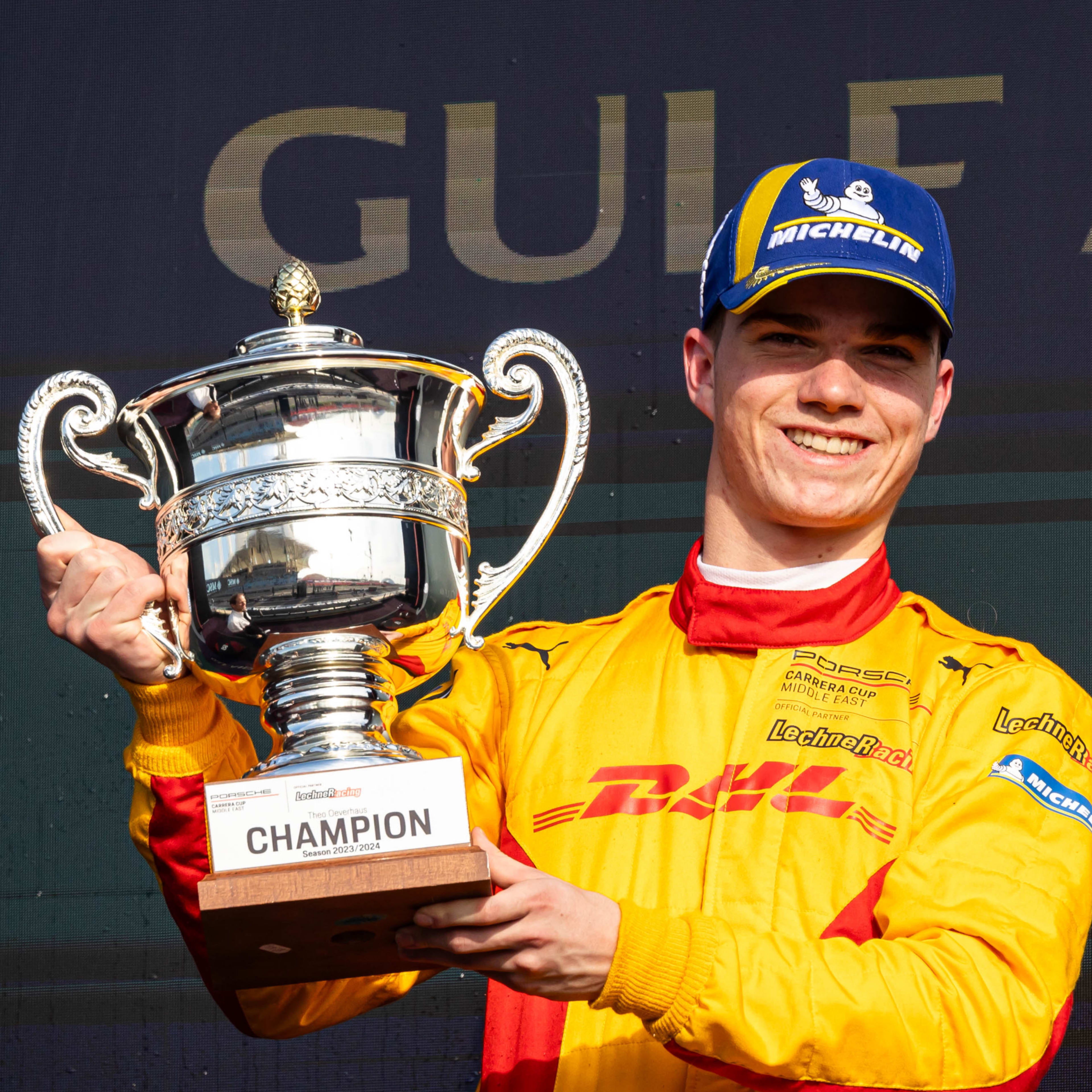 Theo Oeverhaus holding a cup with orange clothing