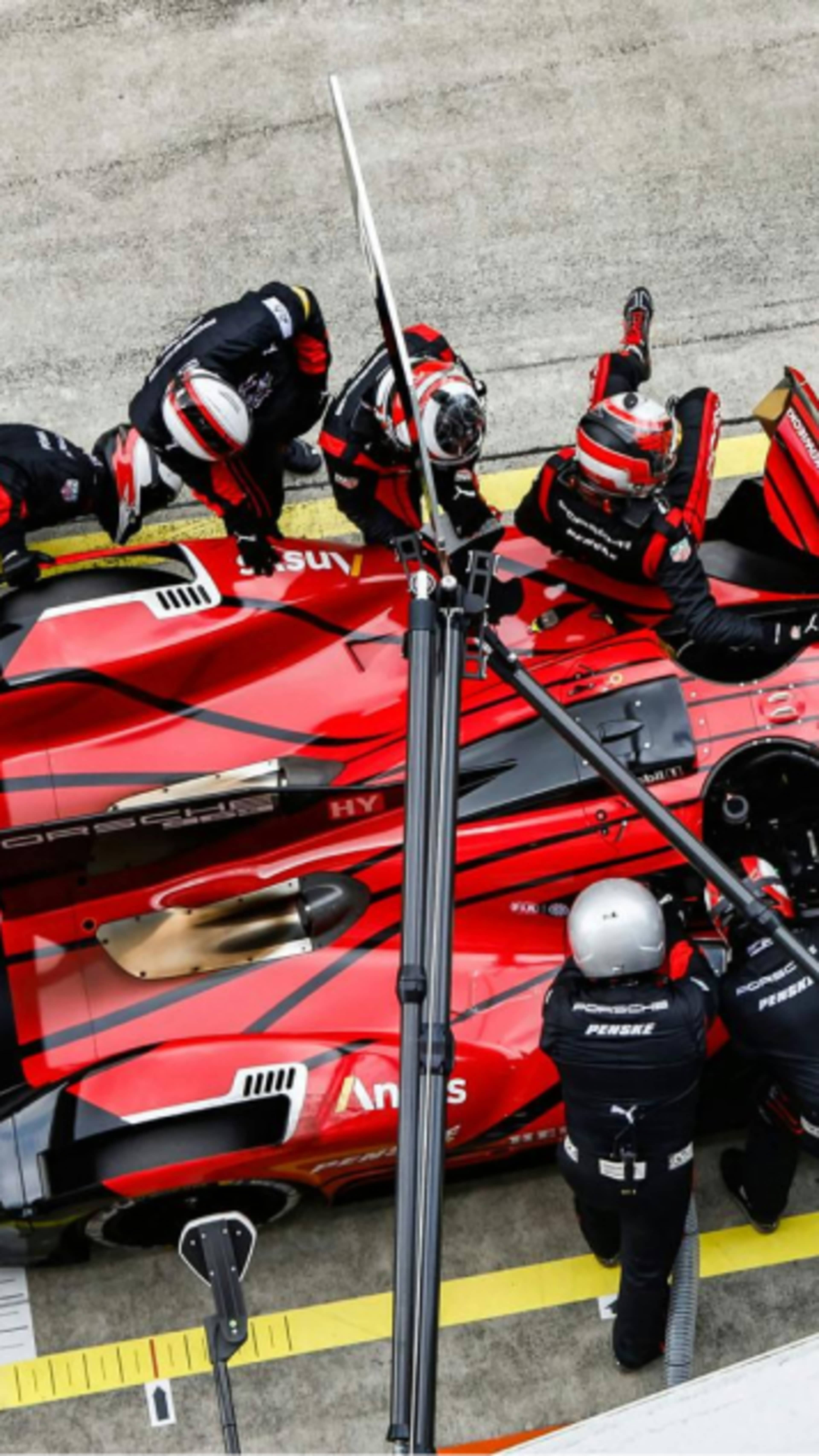 Porsche car in a pit stop seen from above