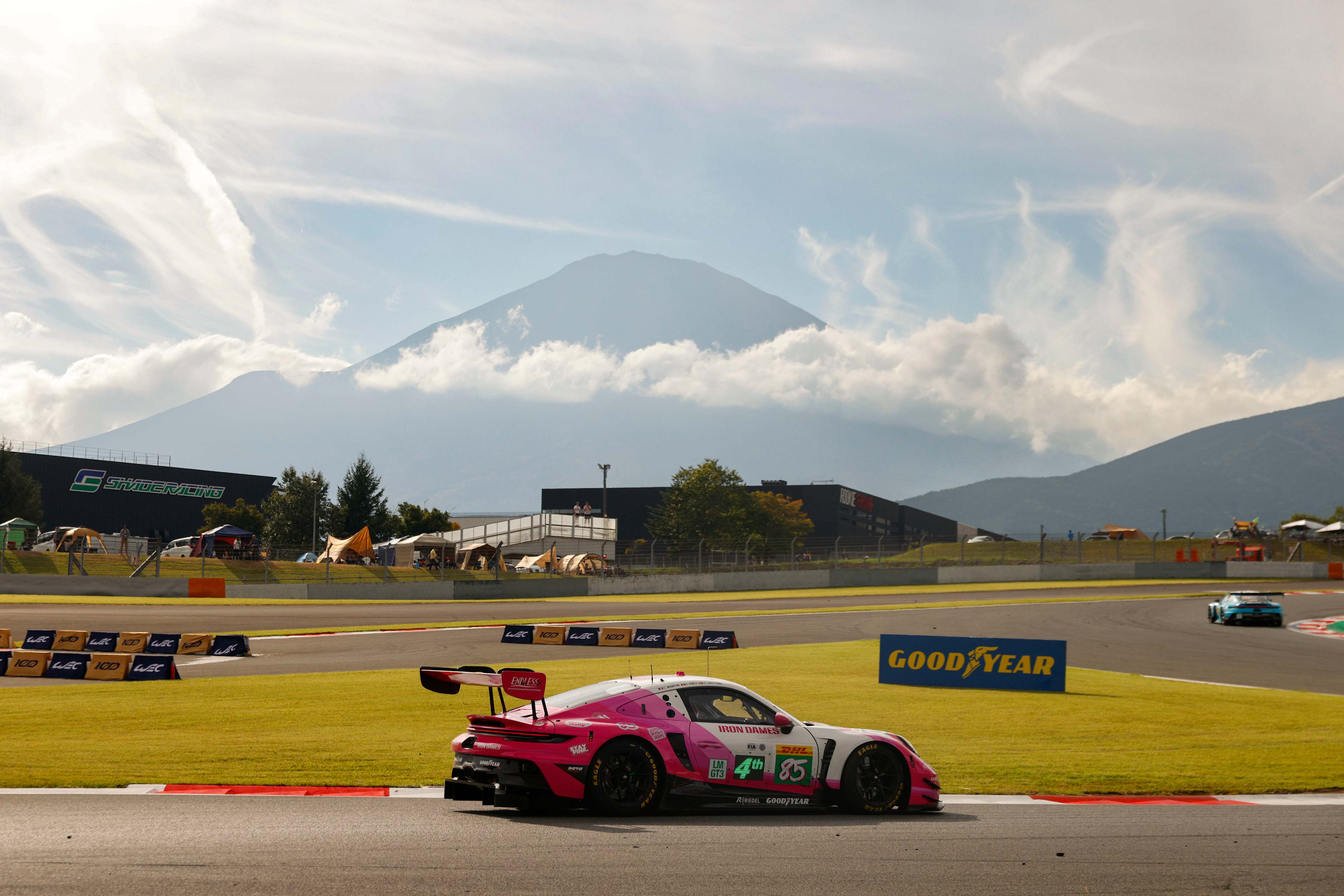 Porsche car on starting grid with person holding the starting sign