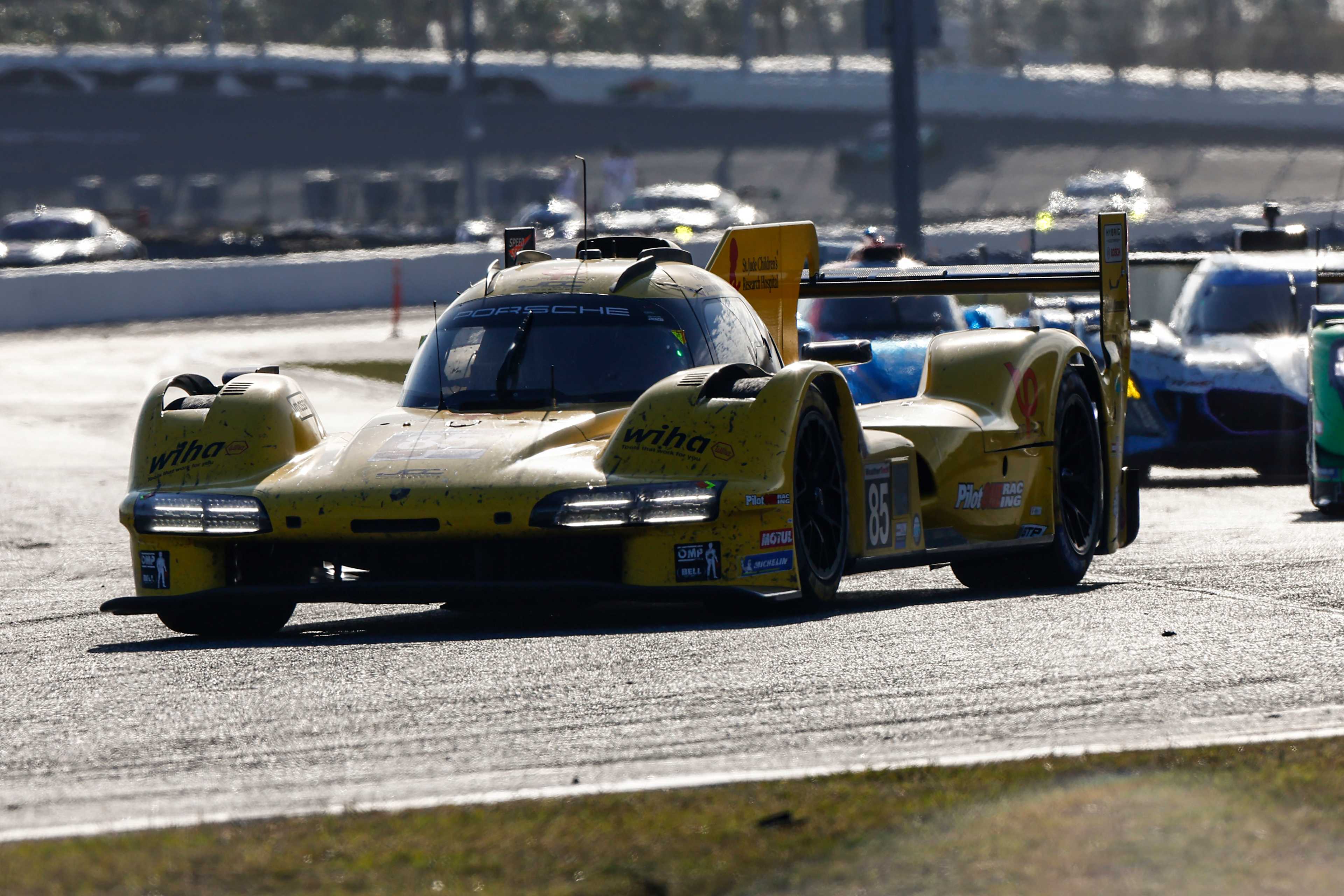 The #85 JDC-Miller MotorSports Porsche turns a corner ahead of an LMP2 car
