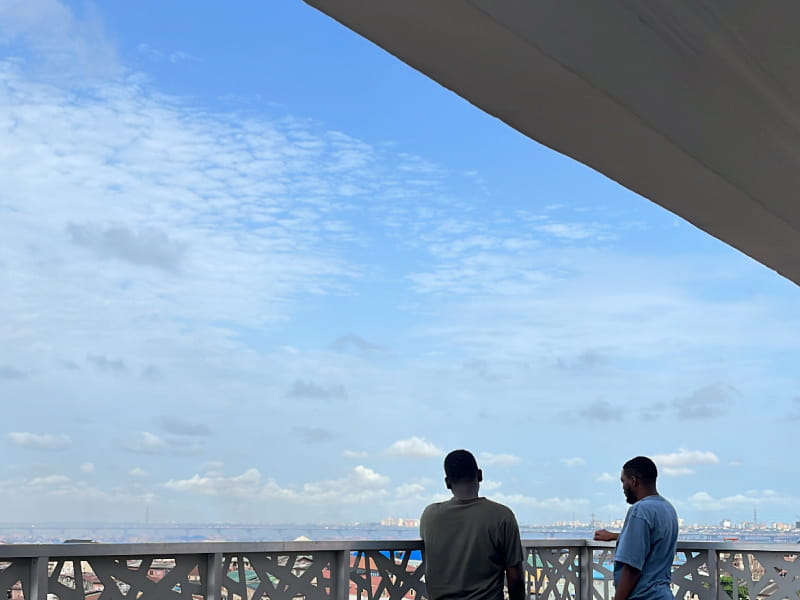 Seyi and Isaac looking over the balcony