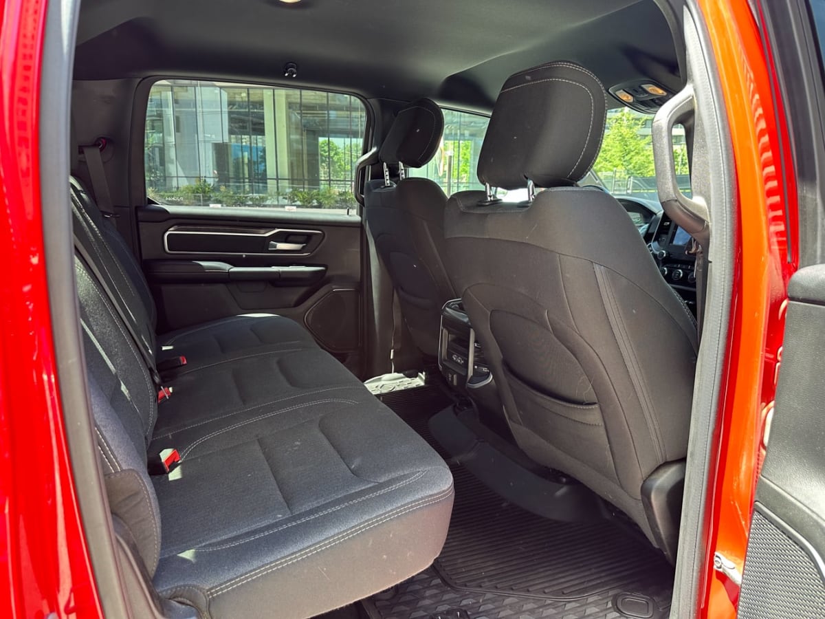 RAM 1500 Big 2021 - Vista interior de pickup roja, asientos traseros de tela color negro en exterior