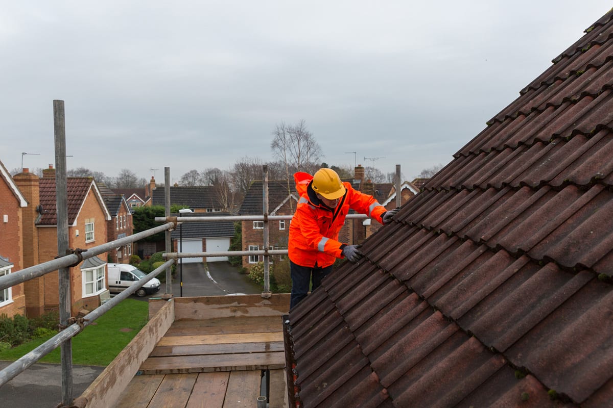 AM Norfolk Roofing Services roofer completing roof repair on residential property