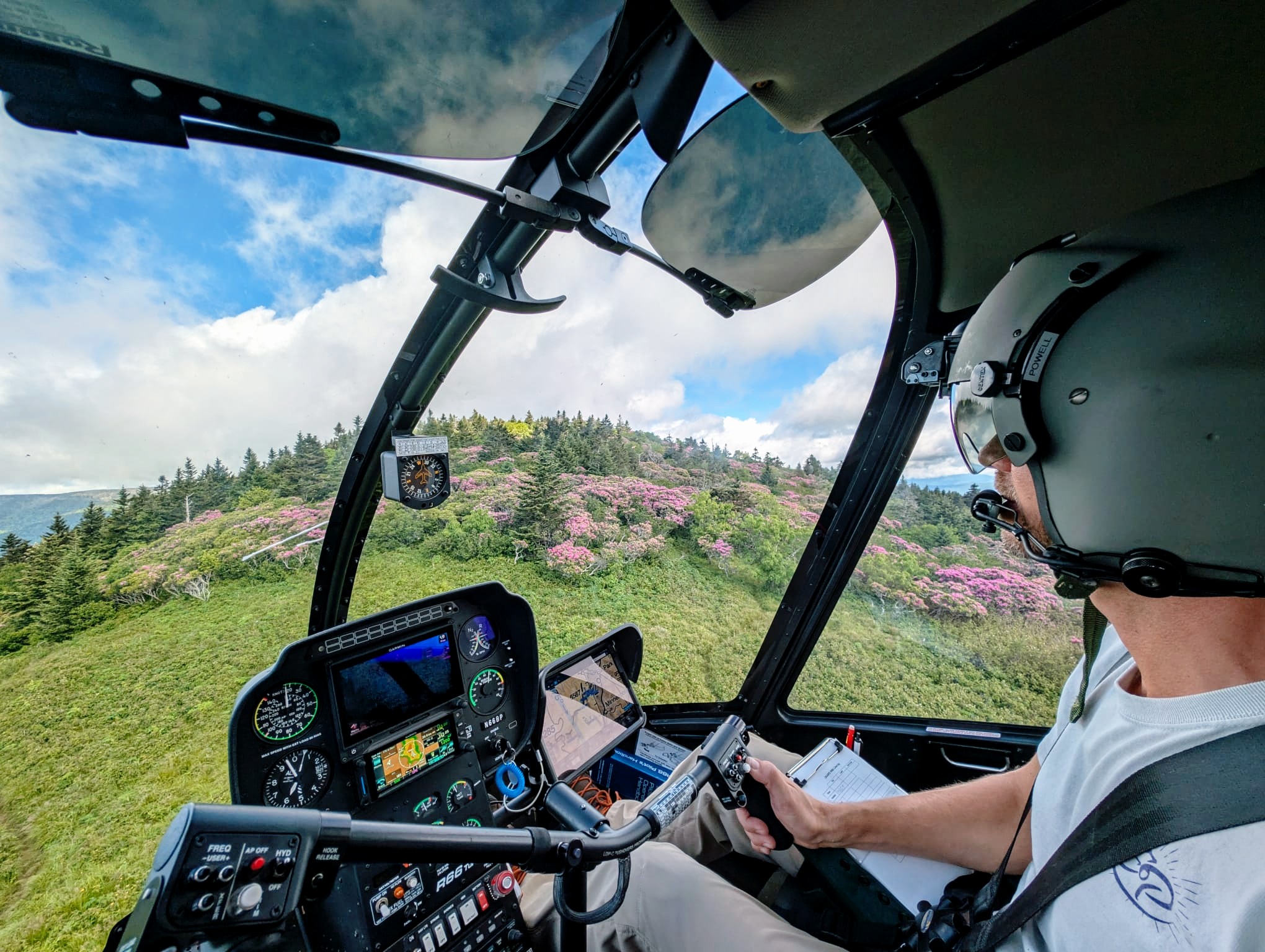 Pilot hovering on mountain-top