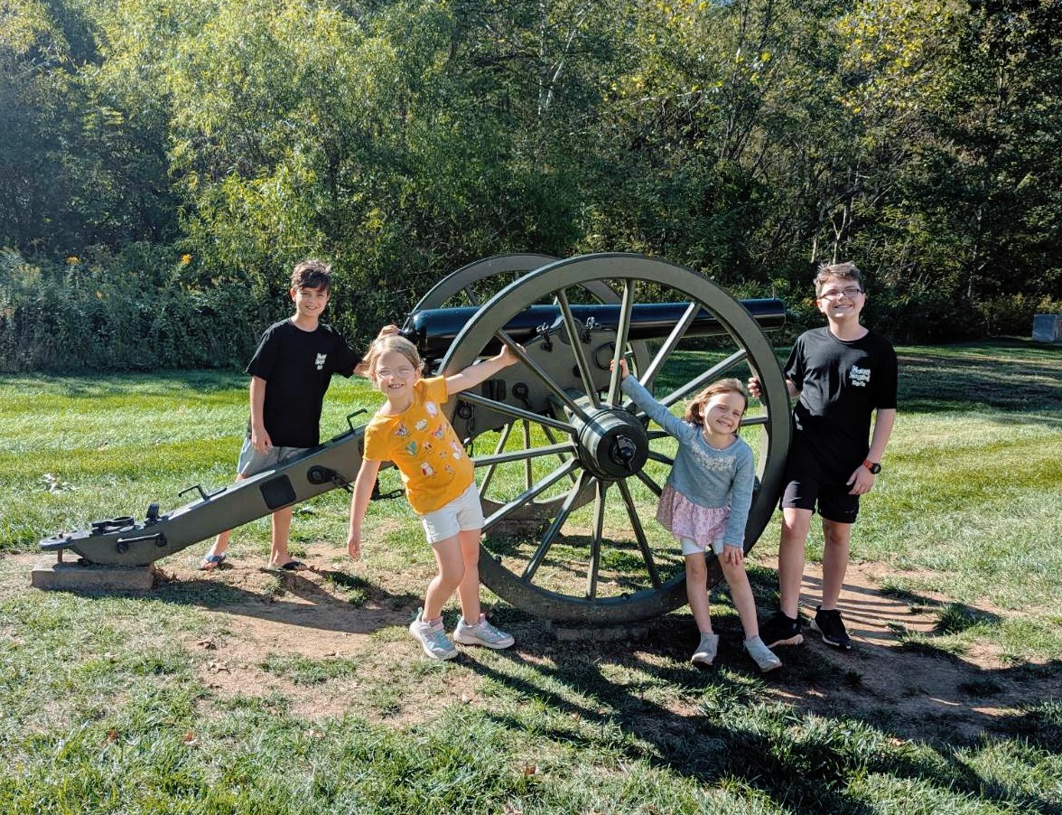 Kids standing around a cannon