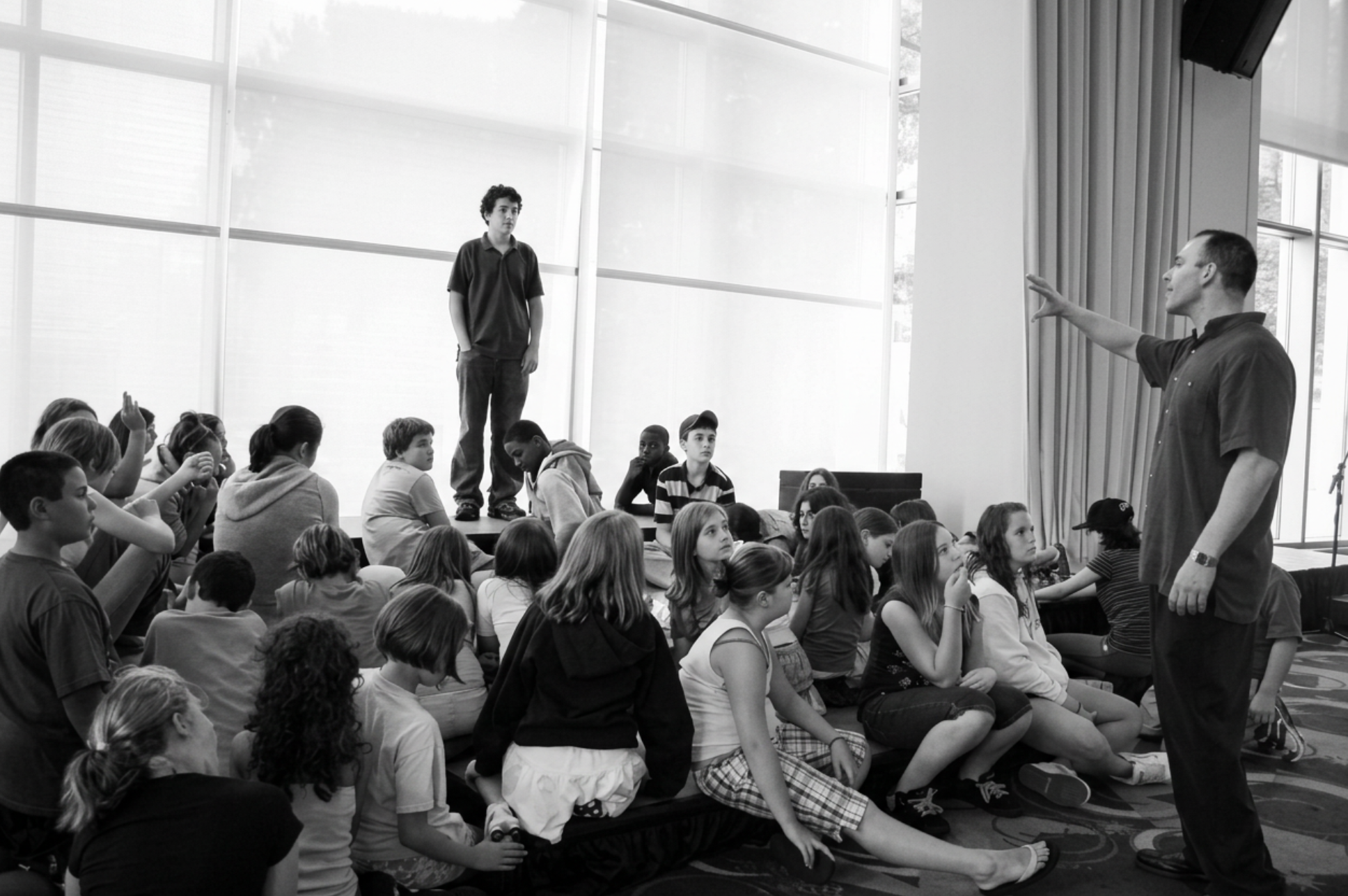 Michael Lamb leading a large group class of young students