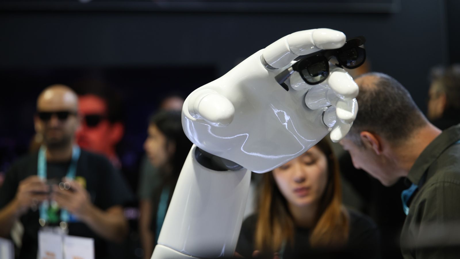 Humanoid robotic hand holding a pair of smart glasses