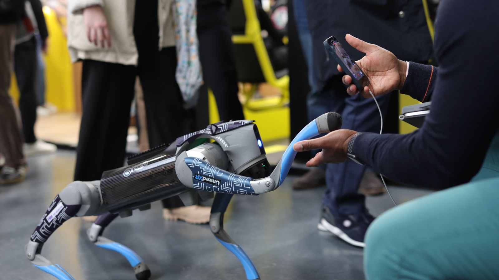 Attendee testing a robotic dog at the expo